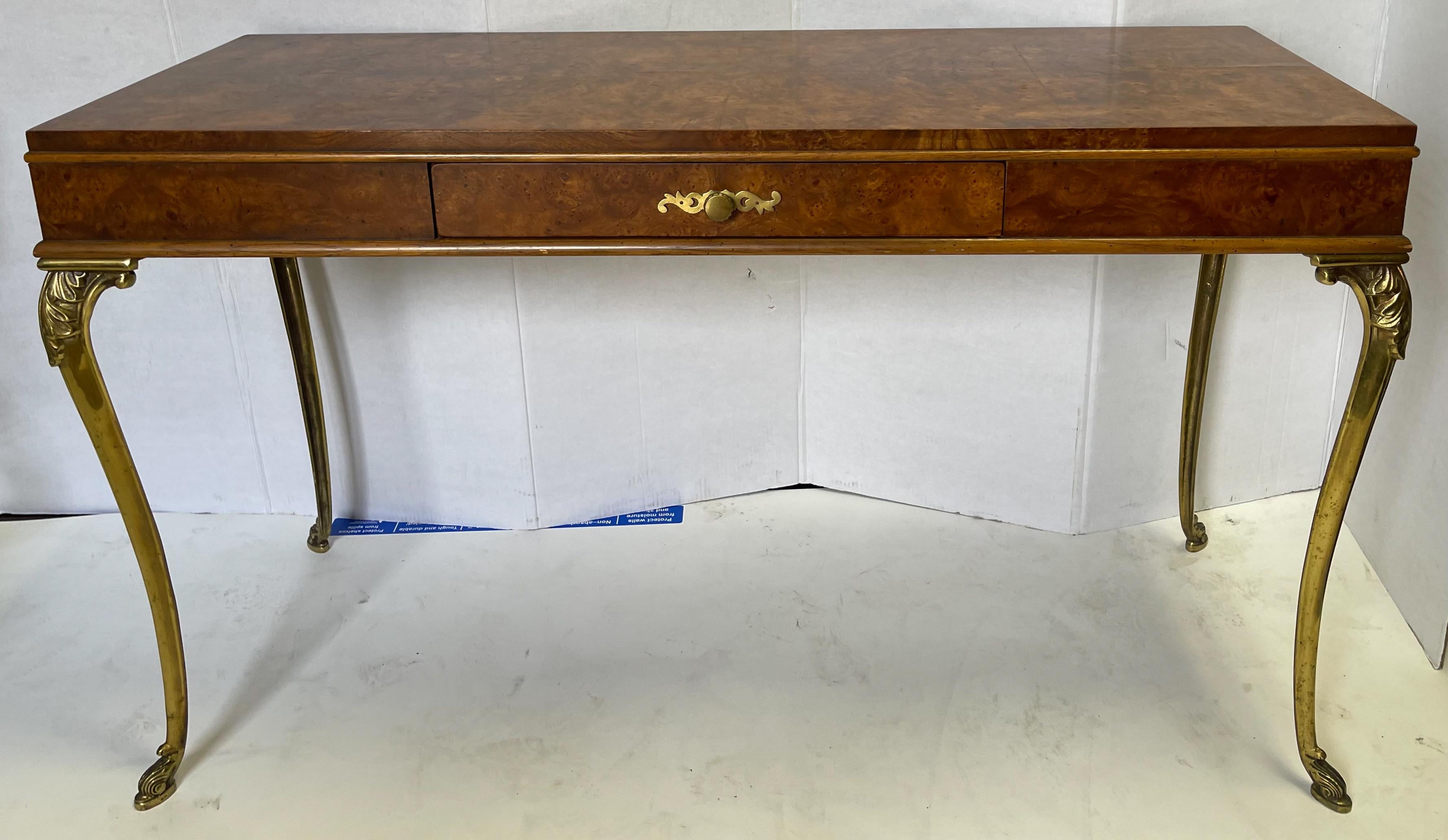 Love this! It is a 1970s Italian neo-classical style desk with sleek elongated brass legs. It could work as a console table too. It is unmarked and in very good condition.