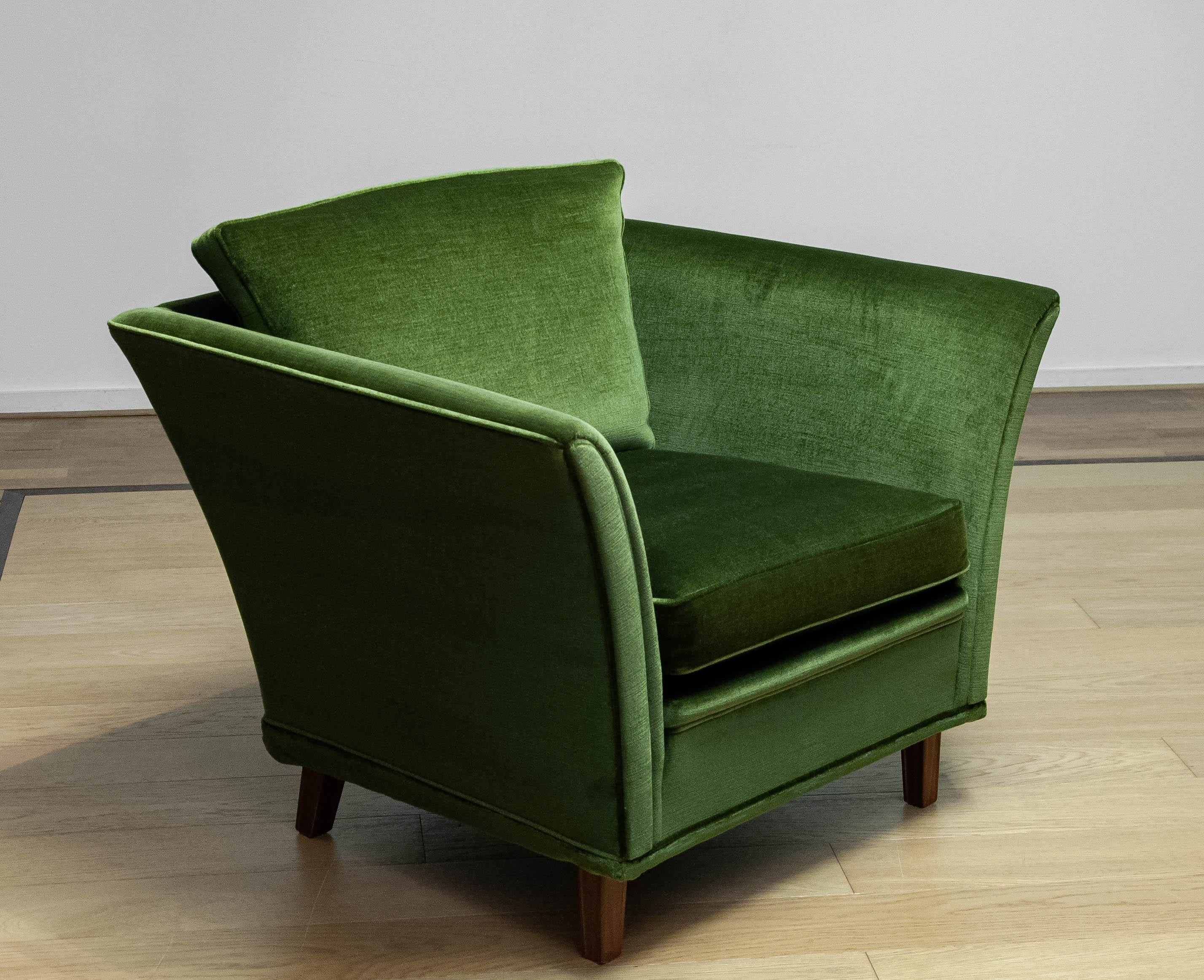 Beautiful neoclassical club chair upholstered with green velvet fabric. The fabric is the original one and stil in very good and clean condition. Allover this chair in in very good condition. Please note that we have two chairs in our gallery.