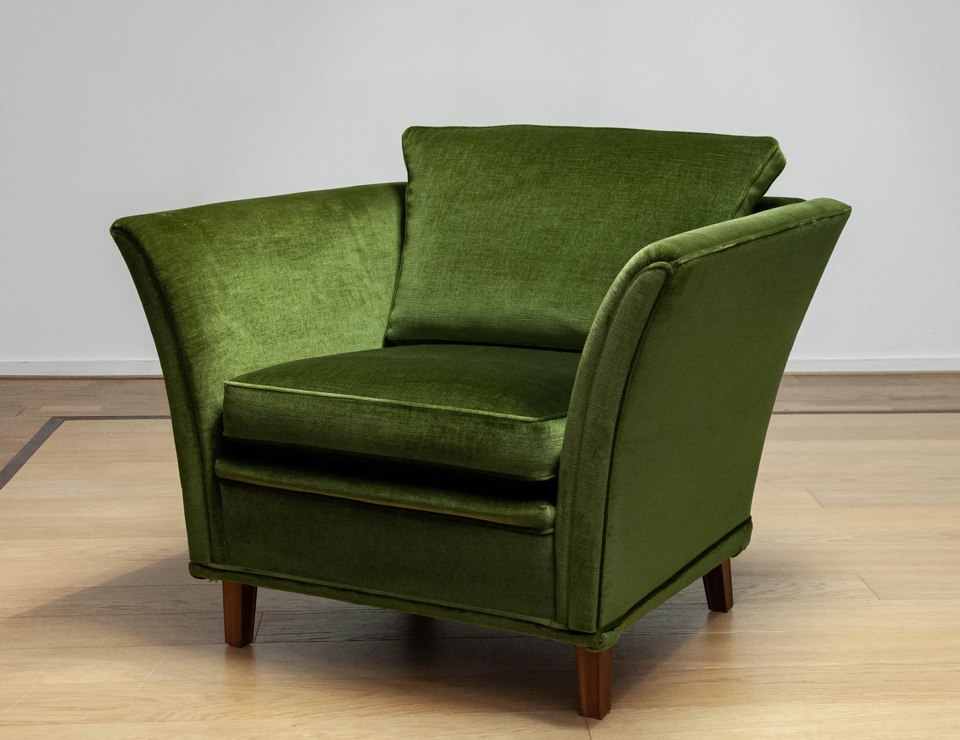 Beautiful neoclassical club chair upholstered with green velvet fabric. The fabric is the original one and stil in very good and clean condition. Allover this chair in in very good condition. Please note that we have two chairs in our gallery.