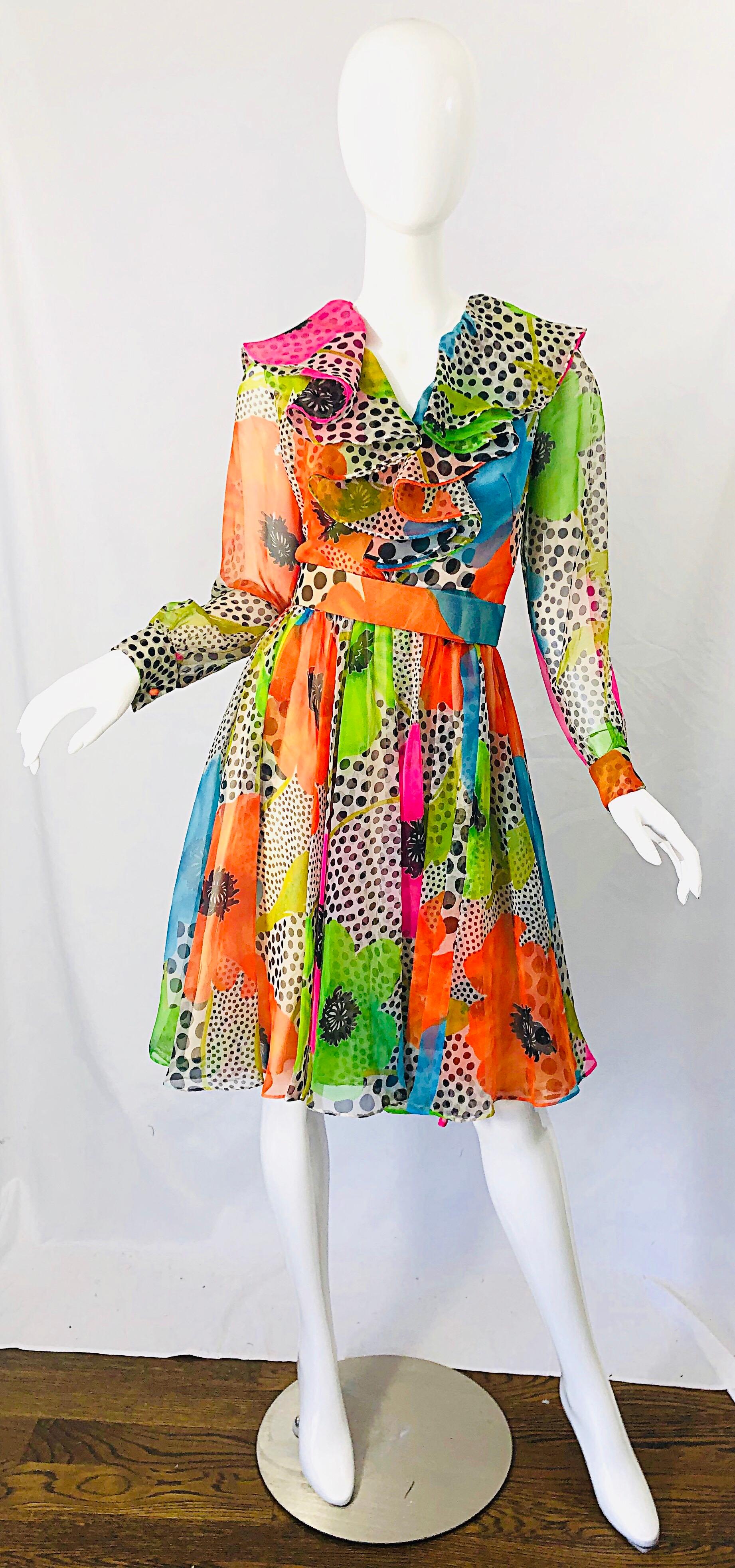 Chic and fun 1970s neon colored flowers and polka dots printed chiffon belted dress ! Features flowers in bright colors of blue, pink, green, and orange throughout. Semi sheer sleeves. Detachable matching belt. Full metal zipper up the back with