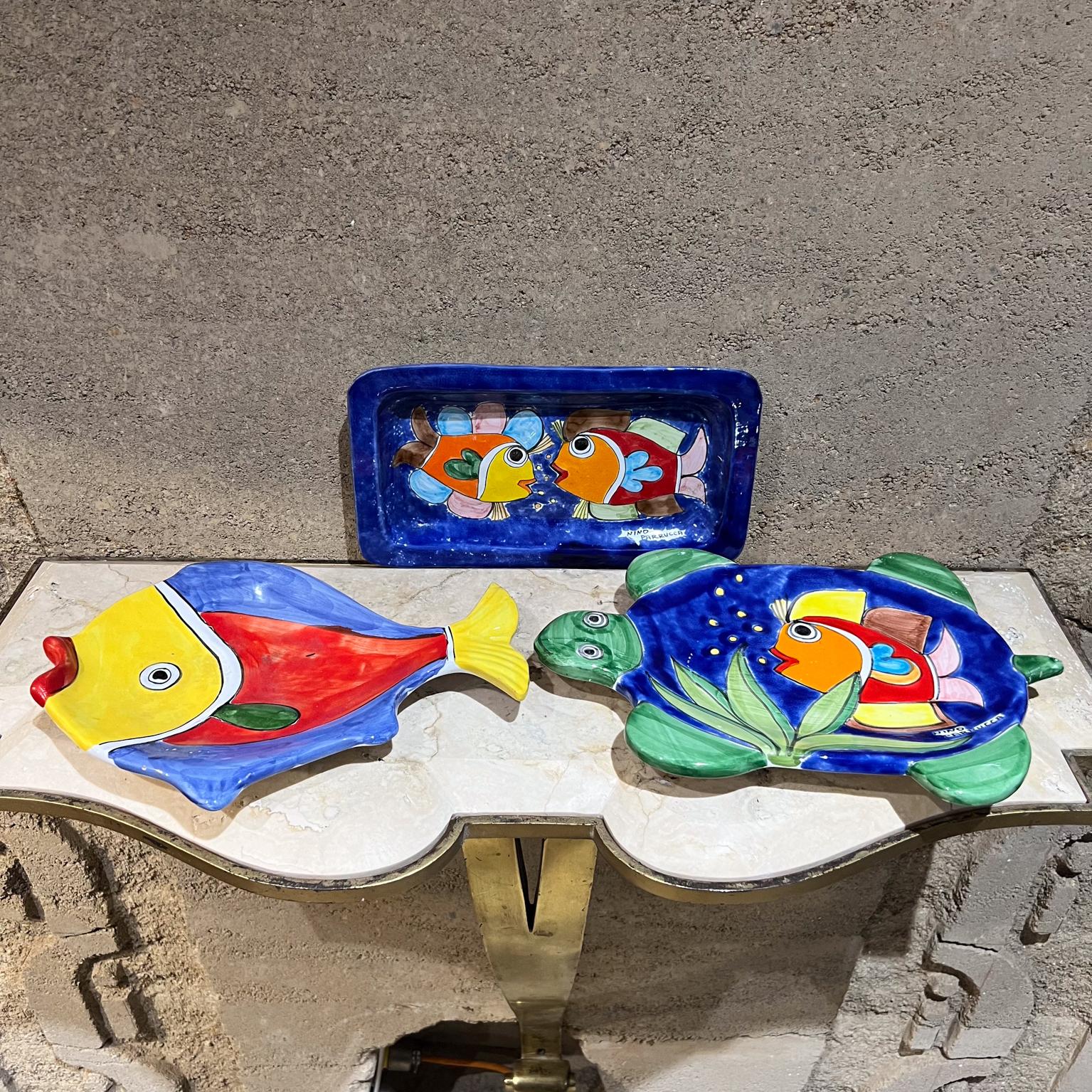 1970s Nino Parrucca Hand Painted Italian Pottery Fish Plate Set Sicily
includes Set of three plates
1.75 h x 11.5 w 8.5 d yellow tail plate
Nick on tail 12.75 long x 1.5 h x 8.25 w turtle fish
Original vintage preowned and unrestored, some