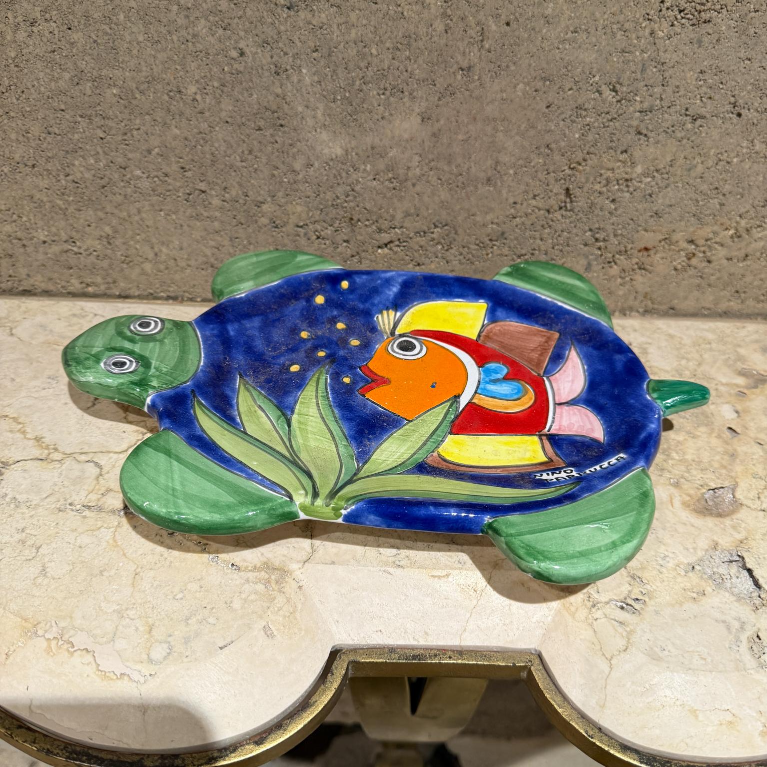 1970s Nino Parrucca Hand Painted Italian Art Pottery Plate Sicily
Turtle Fish decorative plate
1.5 h x 12.75 w x 8.75
Original vintage preowned wear and use.
Nick at tail repaired, hard to see.
Review images please