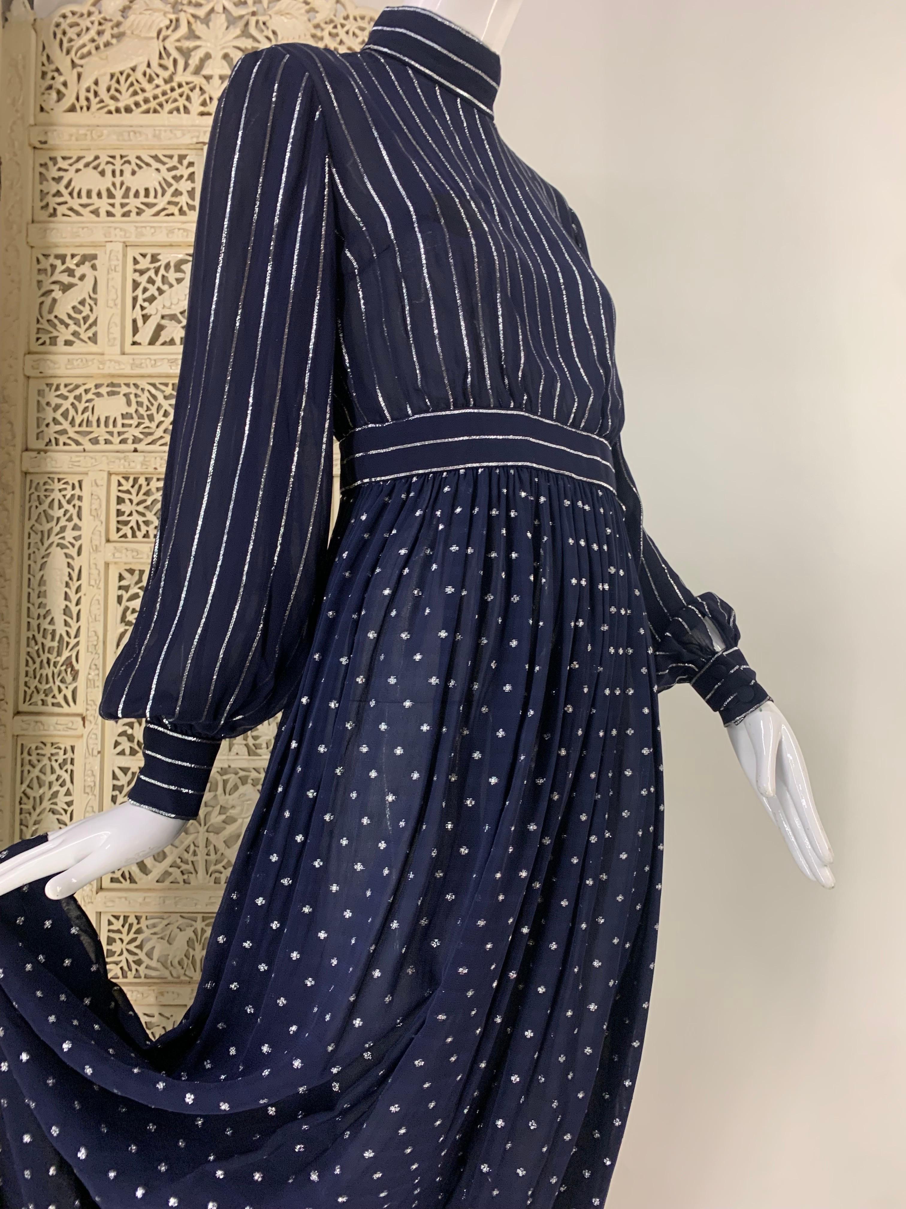 1970s Norman Norell Navy Blue and Silver Lurex Crepe and Chiffon Evening Gown: Banded collar, waist and cuffs. Silver Lurex stripes on bodice and puffed sleeves. Star dotted full length skirt. Back zipper. Lined in chiffon. A true American classic.