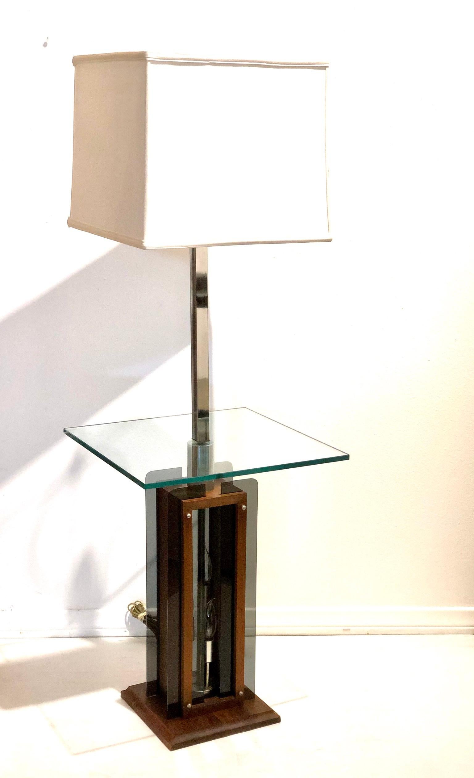 A rare California design table lamp circa 1970s in great condition, a solid walnut base that lights up with smoke Lucite accents, and chrome fittings we have to take it apart and clean it, oil it and rewire it. The lamp its 48