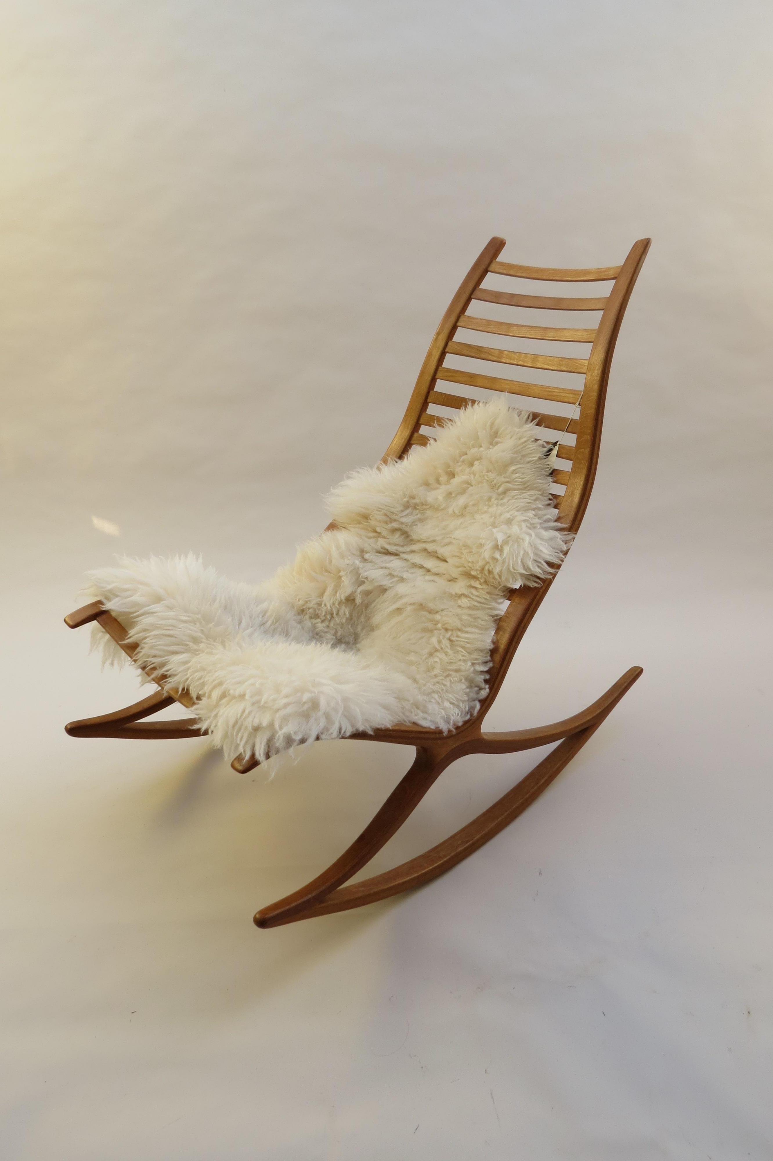 A stylish and sculptural hand produced rocking chair from the 1970s, designed and produced by Robin Williams, UK.

Made from laminated oak with a removable padded leather seat. Retains the original “Selected for Design Centre London”