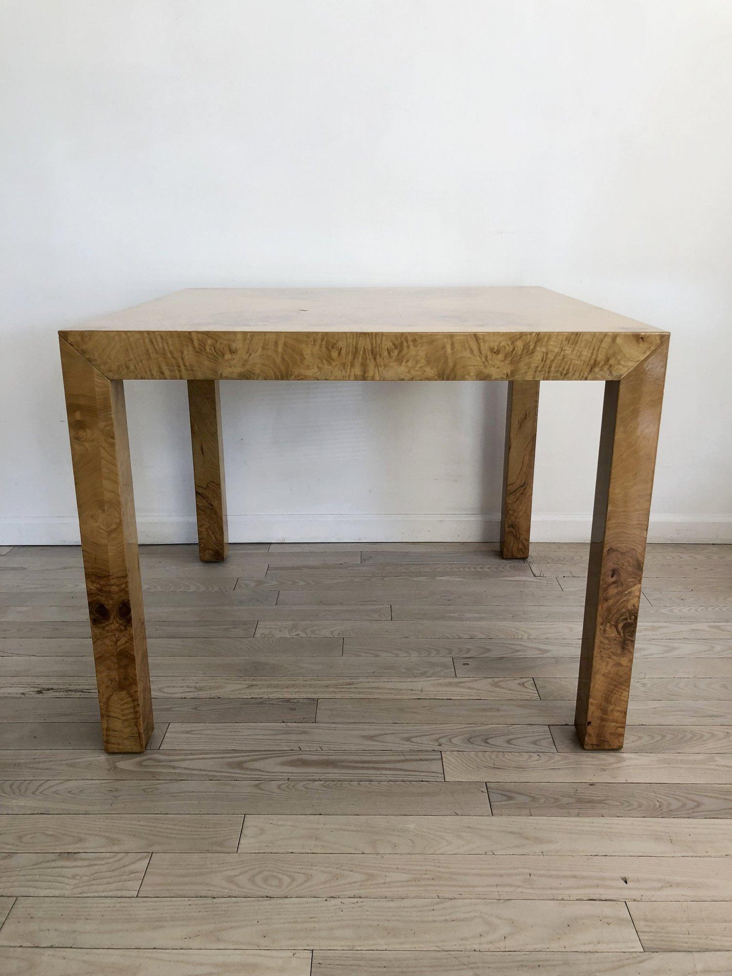 Stunning olive burl wood square dining table by Milo Baughman. Burl wood with resin finish for high shine and protection. Table is from the 1970s. Solid top, does not extend. 
Excellent condition. Minor scuffs from age and use. 
Measures: 36” x