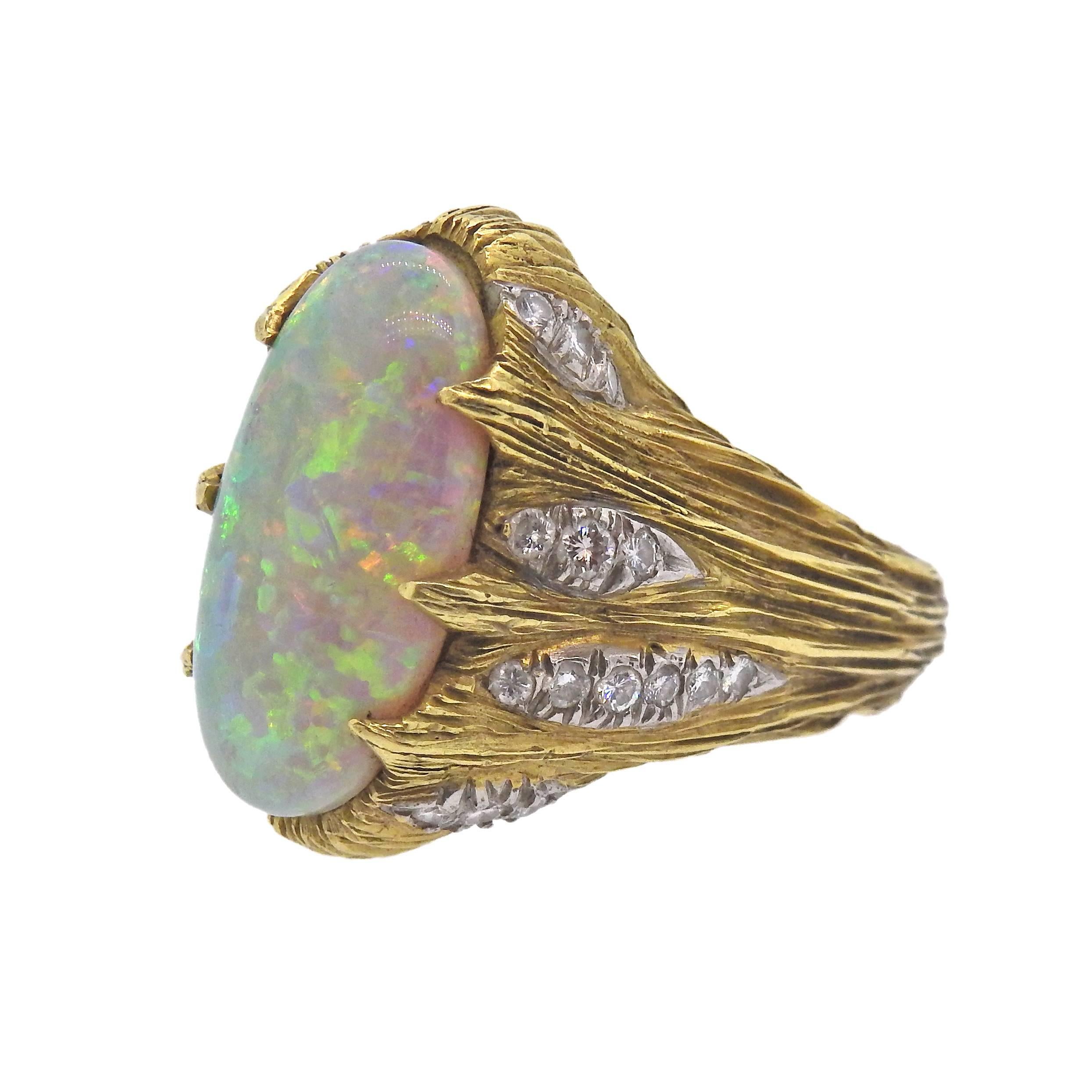 Vintage 1970s 18k gold ring, set with a 19.8mm x 9.6mm opal gemstone, accended with approx. 0.20ctw in diamonds. Ring size - 6 3/4, ring top is 22mm wide , weighs 17.8 grams. 