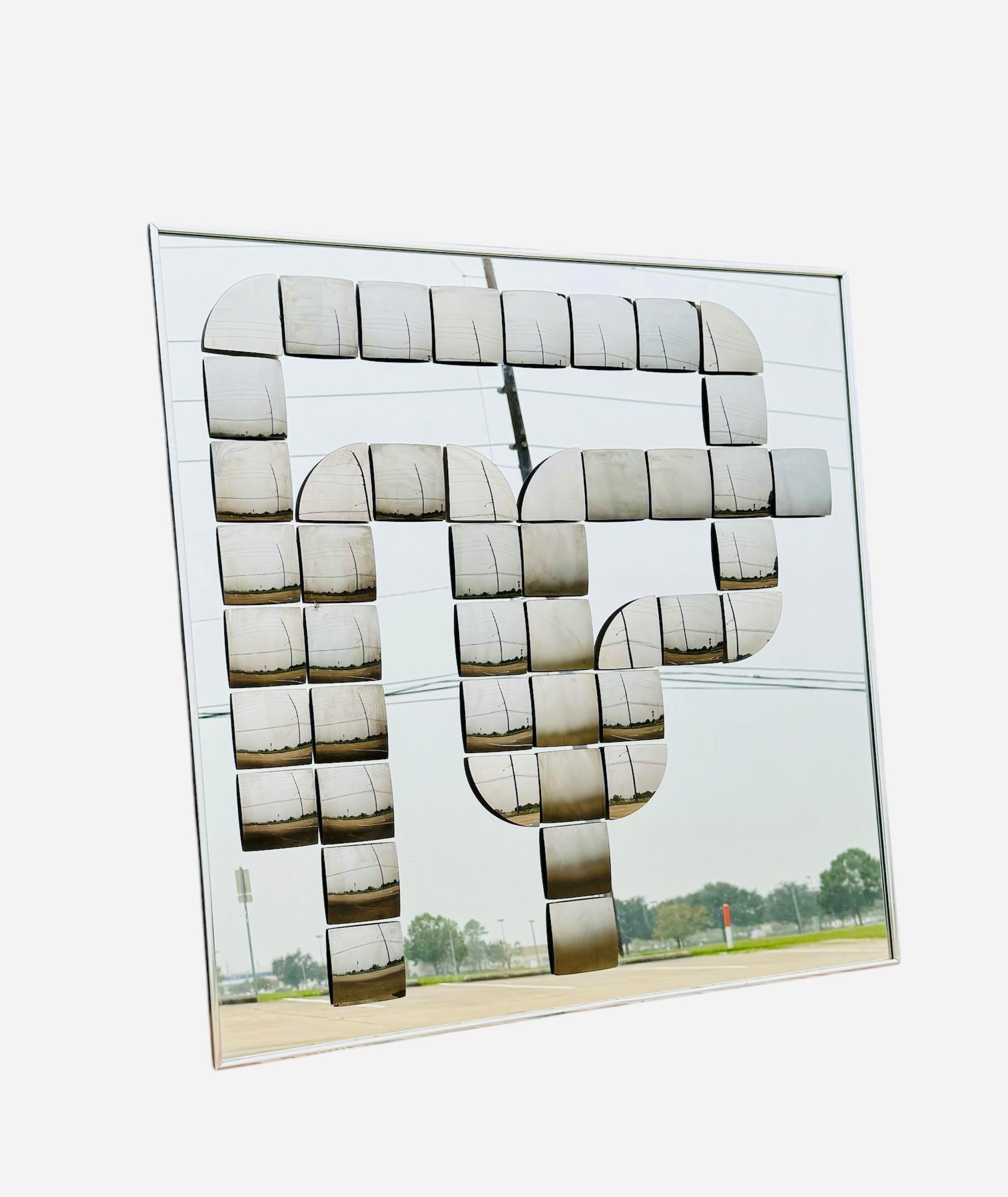 1970's Optical Art bronzed mirror wall sculpture by Hal Bienenfeld
USA, Circa 1970s.
An exceptional example in lightly bronzed mirror, with 47 raised applied tinted mirrored geometric shapes in a centered abstract design.
Framed in a polished chrome