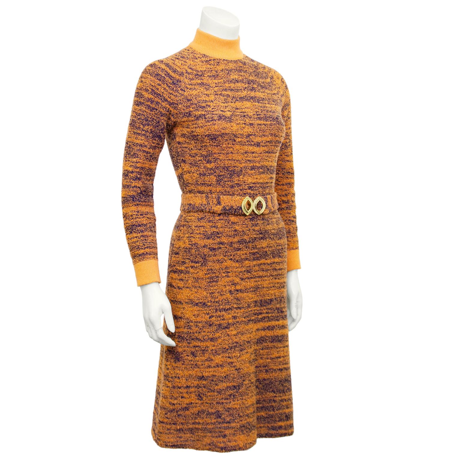 Super cute 1970s marled knit turtleneck dress in tangerine orange and navy blue. Orange ribbed collar and cuffs. Long sleeve and slight a-line shape. Optional matching waist belt with gold tone buckle. Perfect with knee high boots in the fall.