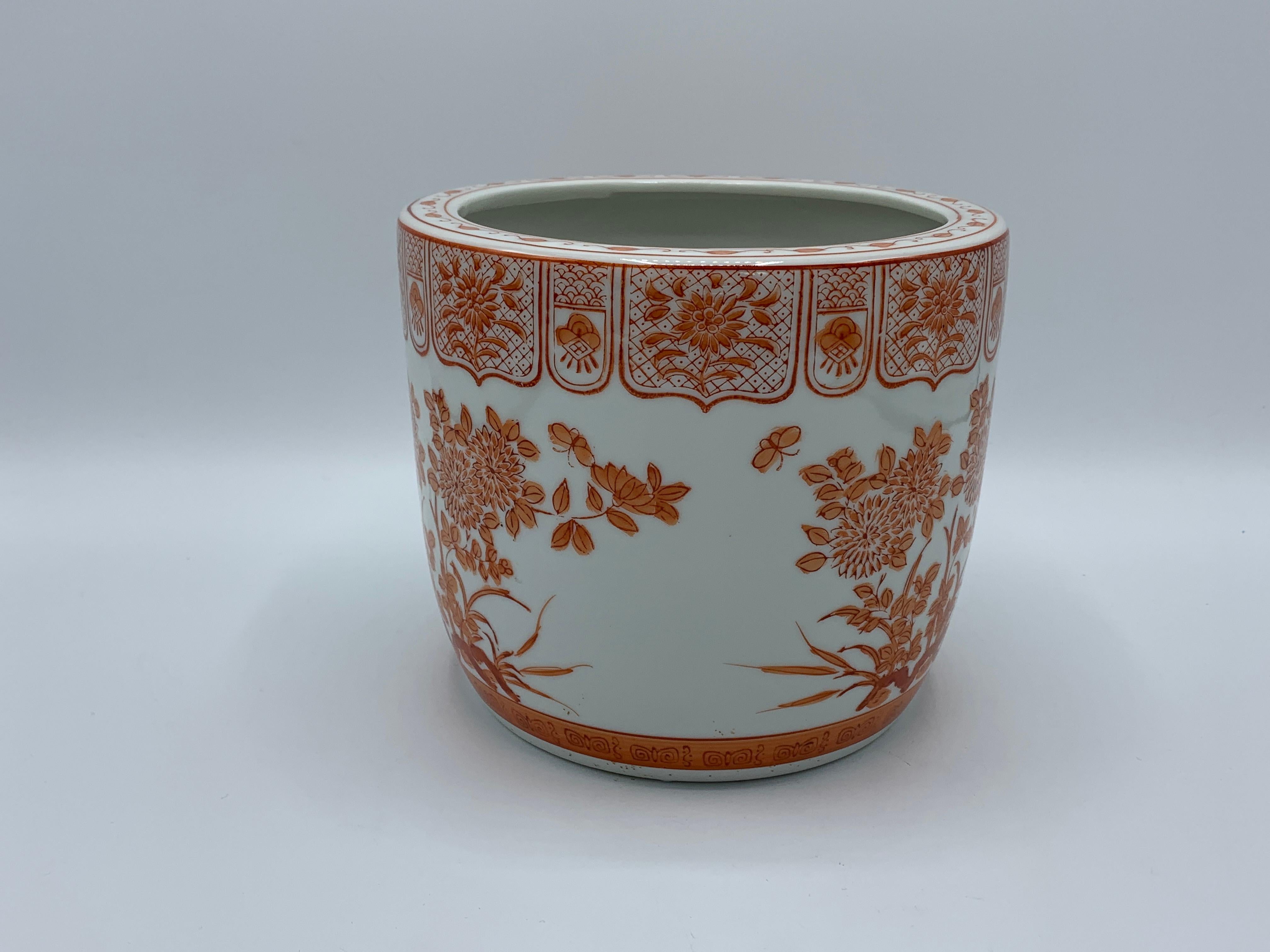 Offered is a stunning, 1970s chinoiserie orange and white cachepot with a floral motif all-over.