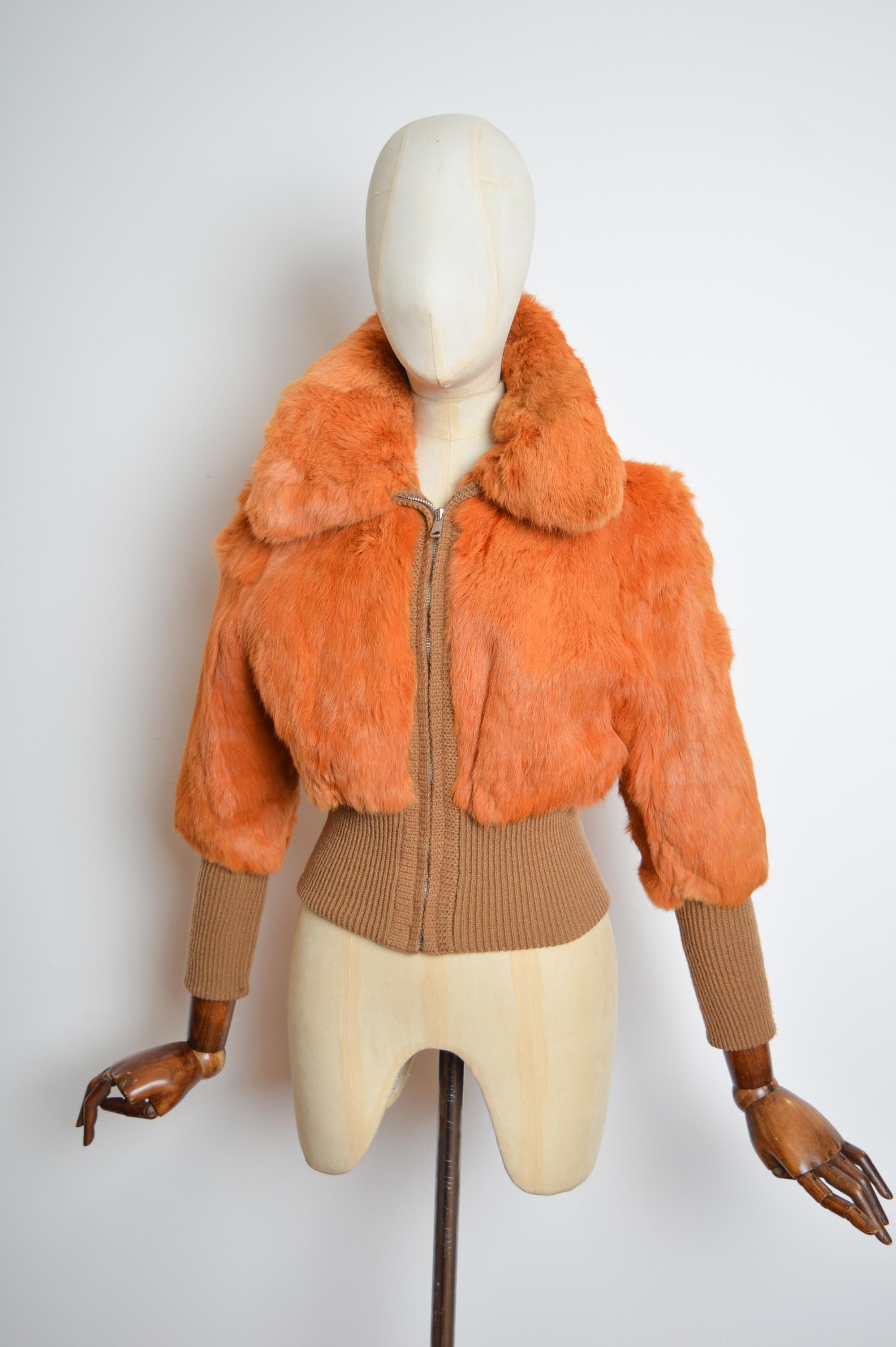 Chic 1970s Orange Coney fur Bomber jacket crafted from Silky Fur and Stretchy wool panels featuring a chrome zip down front closure with a Smooth burgundy satin lined interior.
Pit to Pit; 17.5”
Nape to Hem; 21” 
Waist; 26-28”
Size; U.K. 6-8 /
