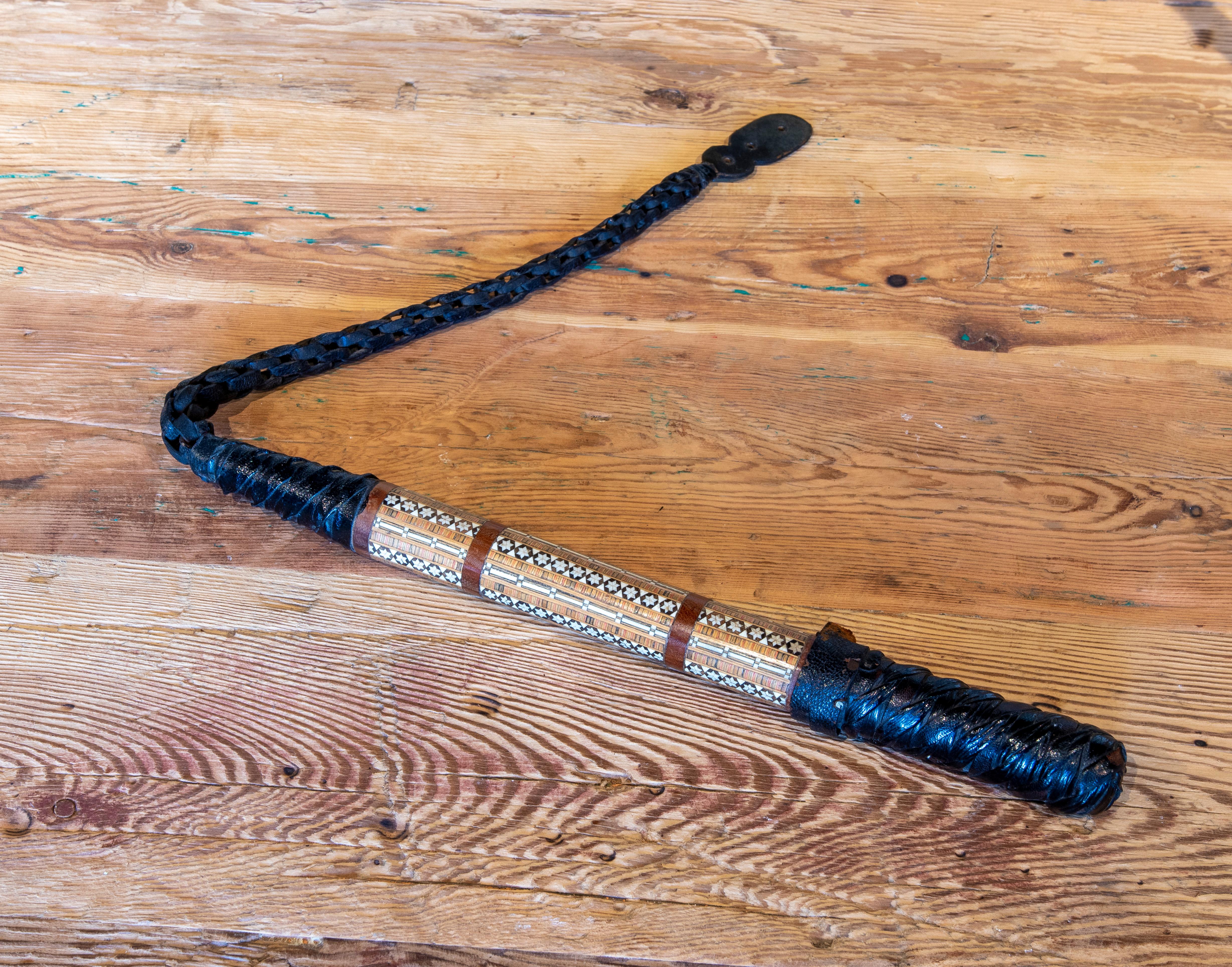 1970s oriental horsewhip of leather and marquetry.