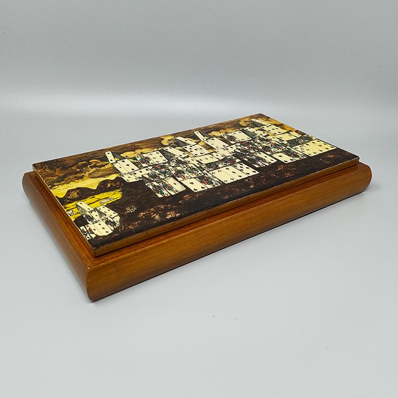 1970s Original astonishing playing cards box by Piero Fornasetti in walnut wood . It's in excellent condition and includes two packs of vintage Dal Negro cards, 7 dices, and chips. The box is signed  on the bottom.
Dimension:
11,02 x 6,29 x 1,57