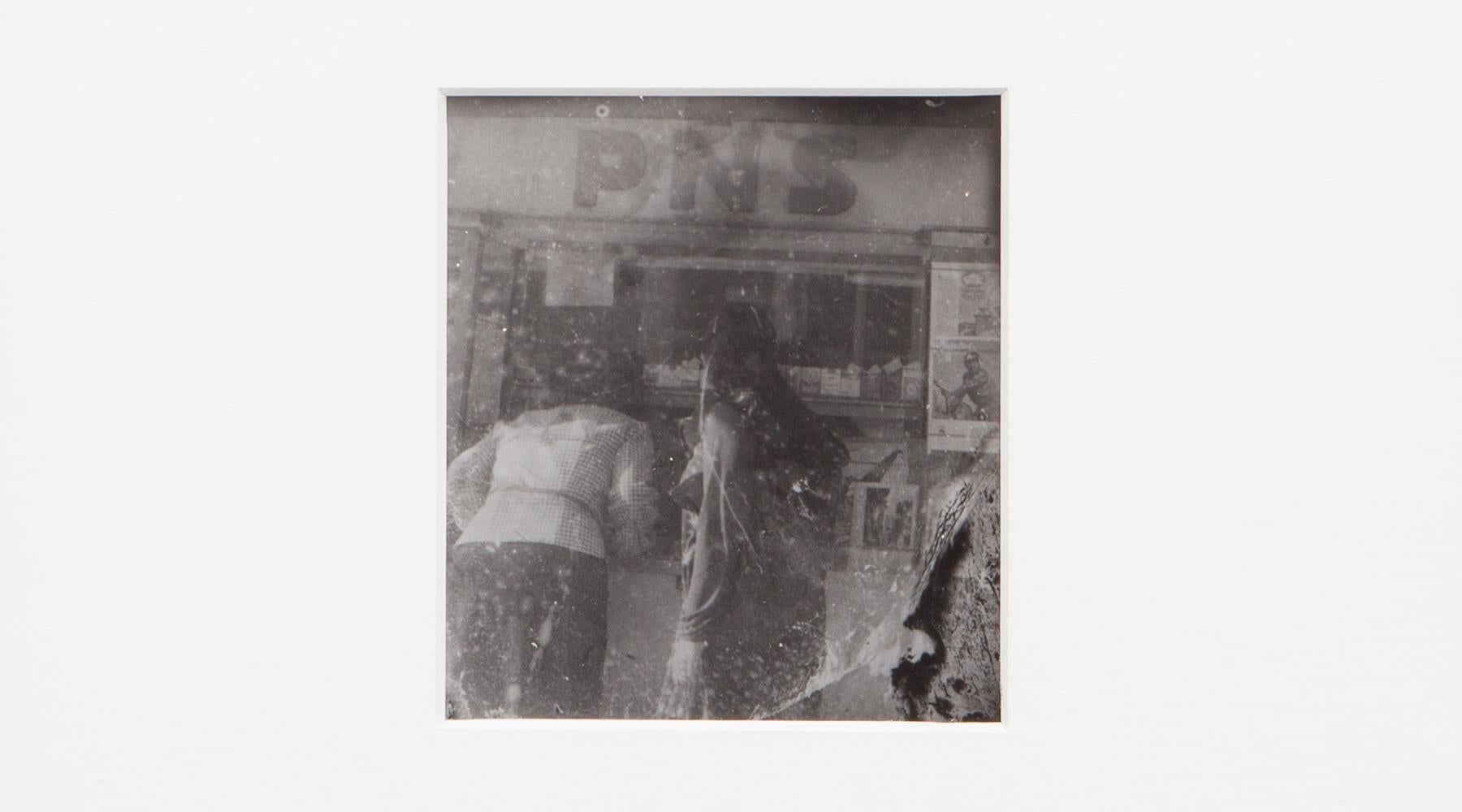 Original Miroslav Tichý b/w Photography from 1970. Unique vintage gelatin silver print. Including black wooden frame in H 27 / W 25.5 cm. This original Miroslav Tichý motif depicts two women photographed from behind while shopping. 

Miroslav Tichý