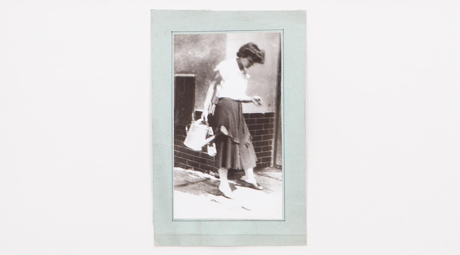Original Miroslav Tichý b/w photography from 1970. Unique vintage gelatin silver print. Including black wooden frame in H 39.5 / W 29.5 cm. The picture shows a lady with a watering can in her hand.

Miroslav Tichý was a Czech photographer who