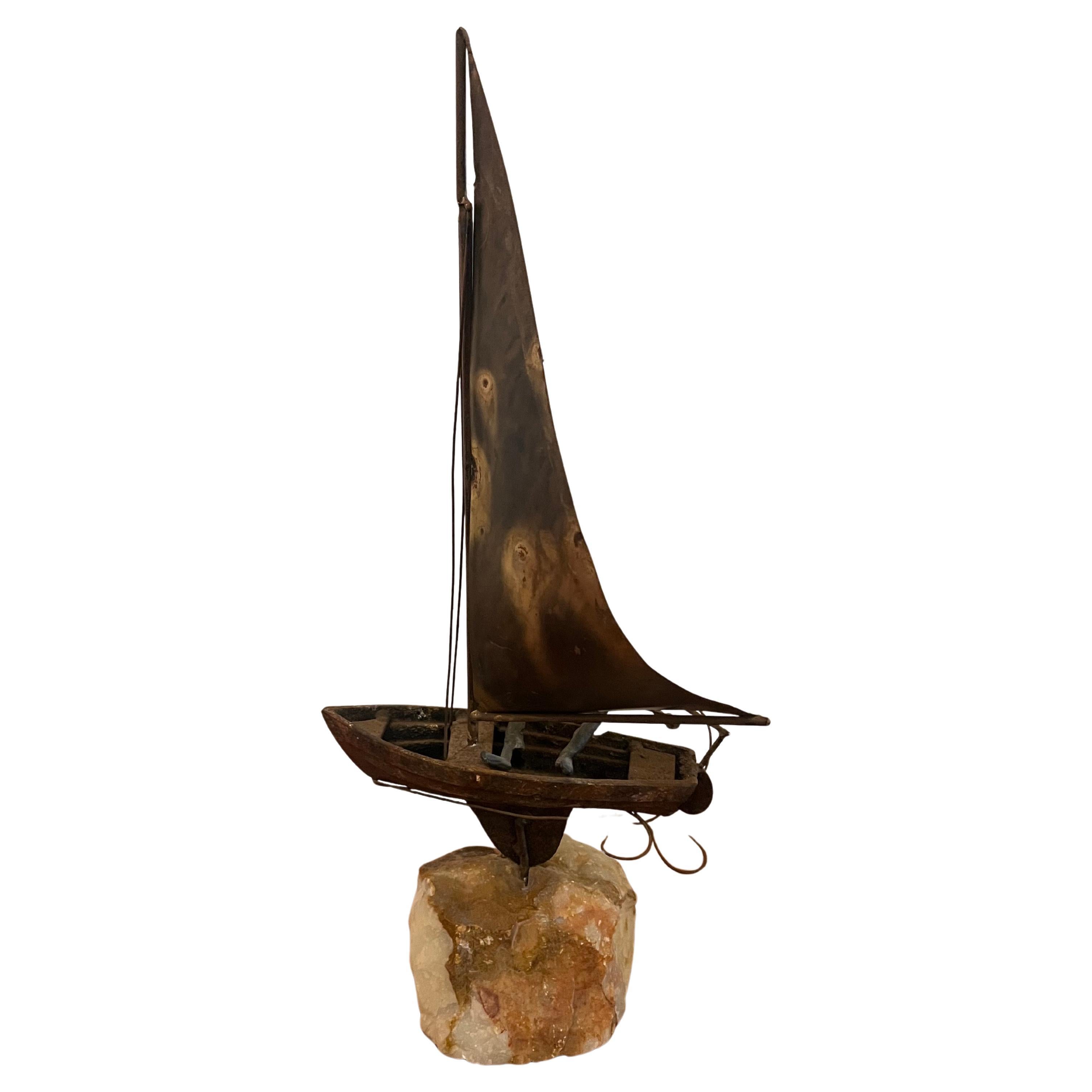 

This **fabulous mid-century sculpture** by **Curtis Jere** features a **bronze-patinated figure** gracefully sailing in a **stylized sailboat**, mounted on a striking piece of **solid quartz rock**. The sculpture is signed on the side of the boat