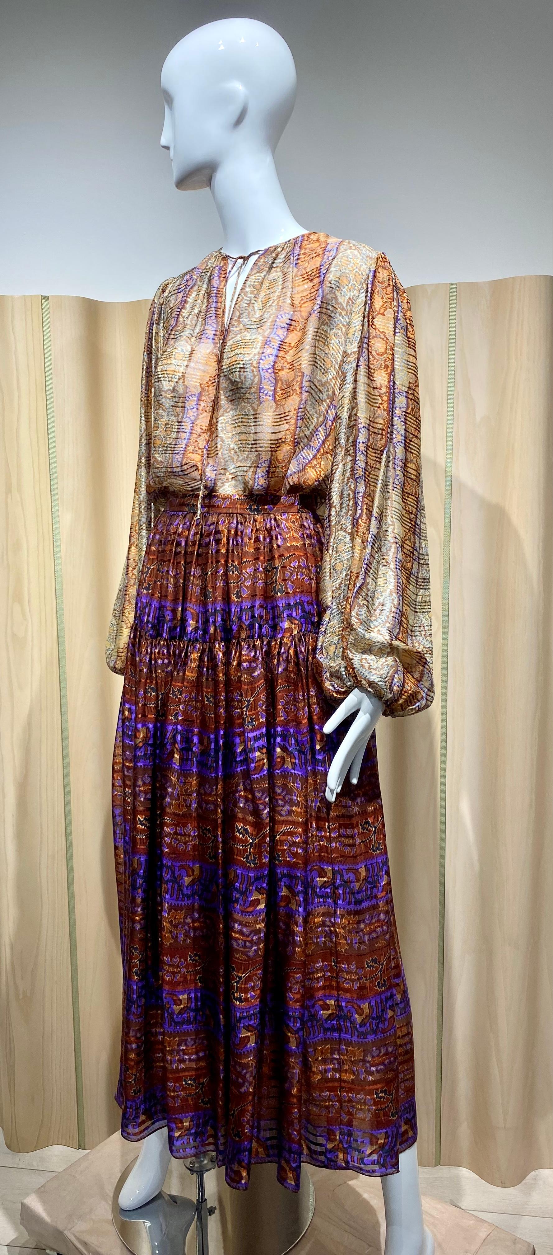 1970s Oscar de la renta brown, creme, gold and purple multi color paisley print peasant long sleeve blouse and skirt set.
Blouse fit size Large 
Bust: 44” / Waist: 44” / Shoulder: 16”/ Sleeves: 25”
Skirt fit size small: Waist: 25” / Skirt Length: 38”