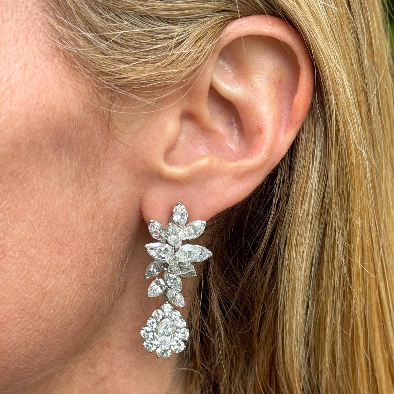 Stunning diamond drop earrings handcrafted by designer Oscar Heyman in platinum and 14 karat white gold. The custom earrings, circa 1970, feature 2 pear shape diamonds weighing 2.46 CTW. The pears can be worn alone as studs with retractable posts.