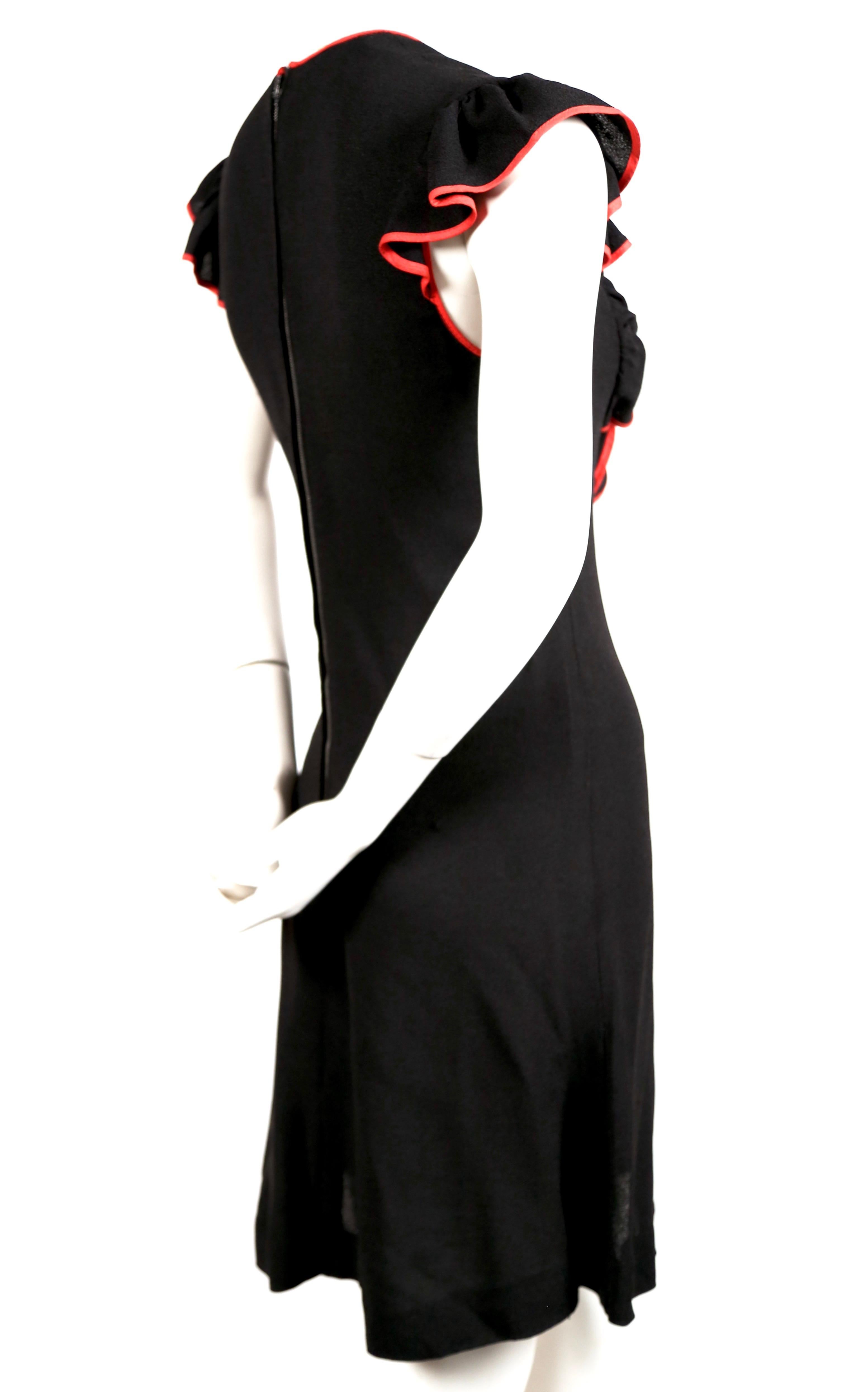 Jet-black, moss crepe dress with cut out and red trim designed by Ossie Clark for Radley. Best fits a US 4-6. Approximate measurements: shoulder 14