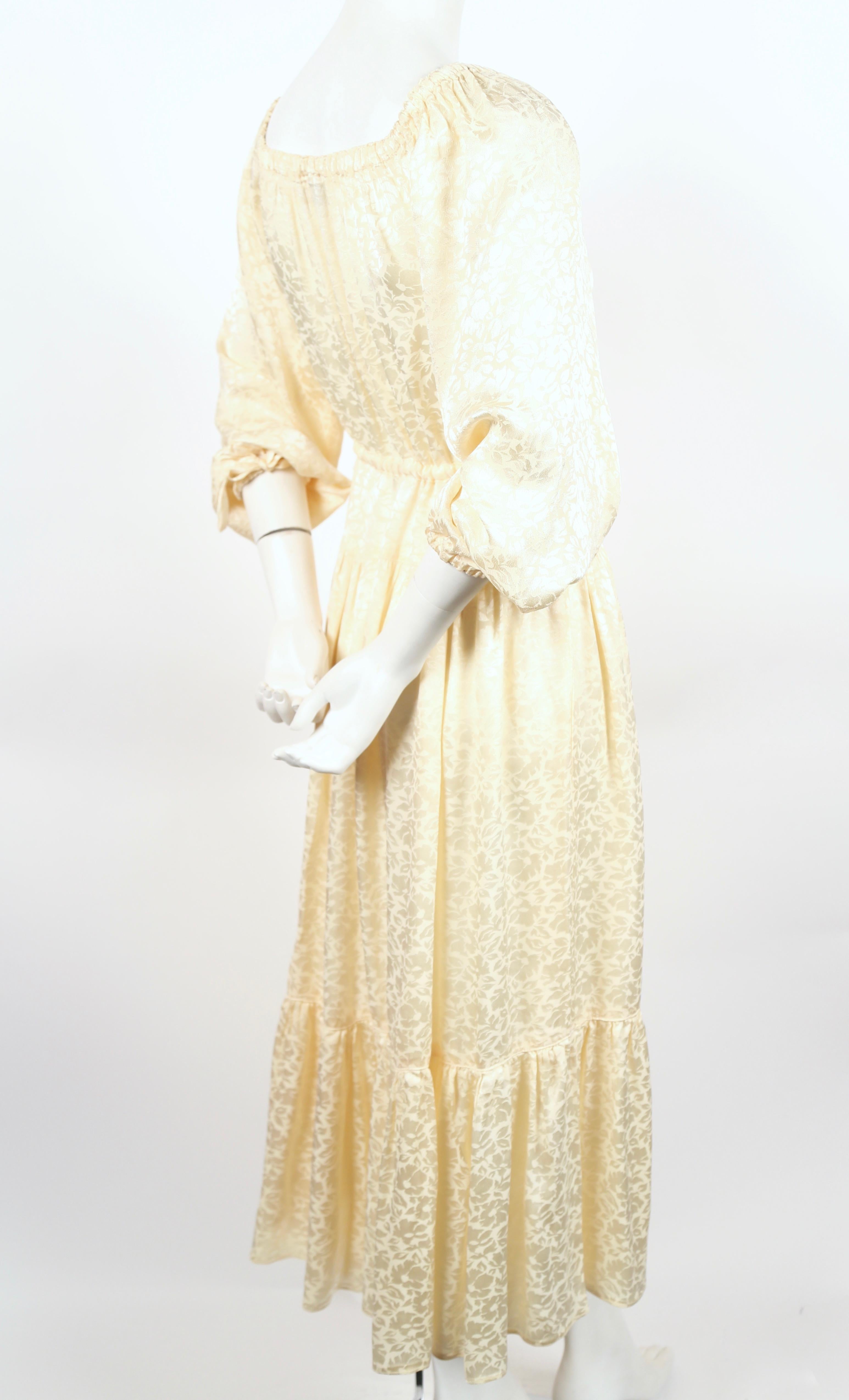 Cream, floral jacquard dress designed by Ossie Clark for Radley dating to the 1970's. Dress would work as a great alternative for a traditional wedding dress.  Dress has an elasticized neckline so it can be worn off the shoulder and has a drawstring