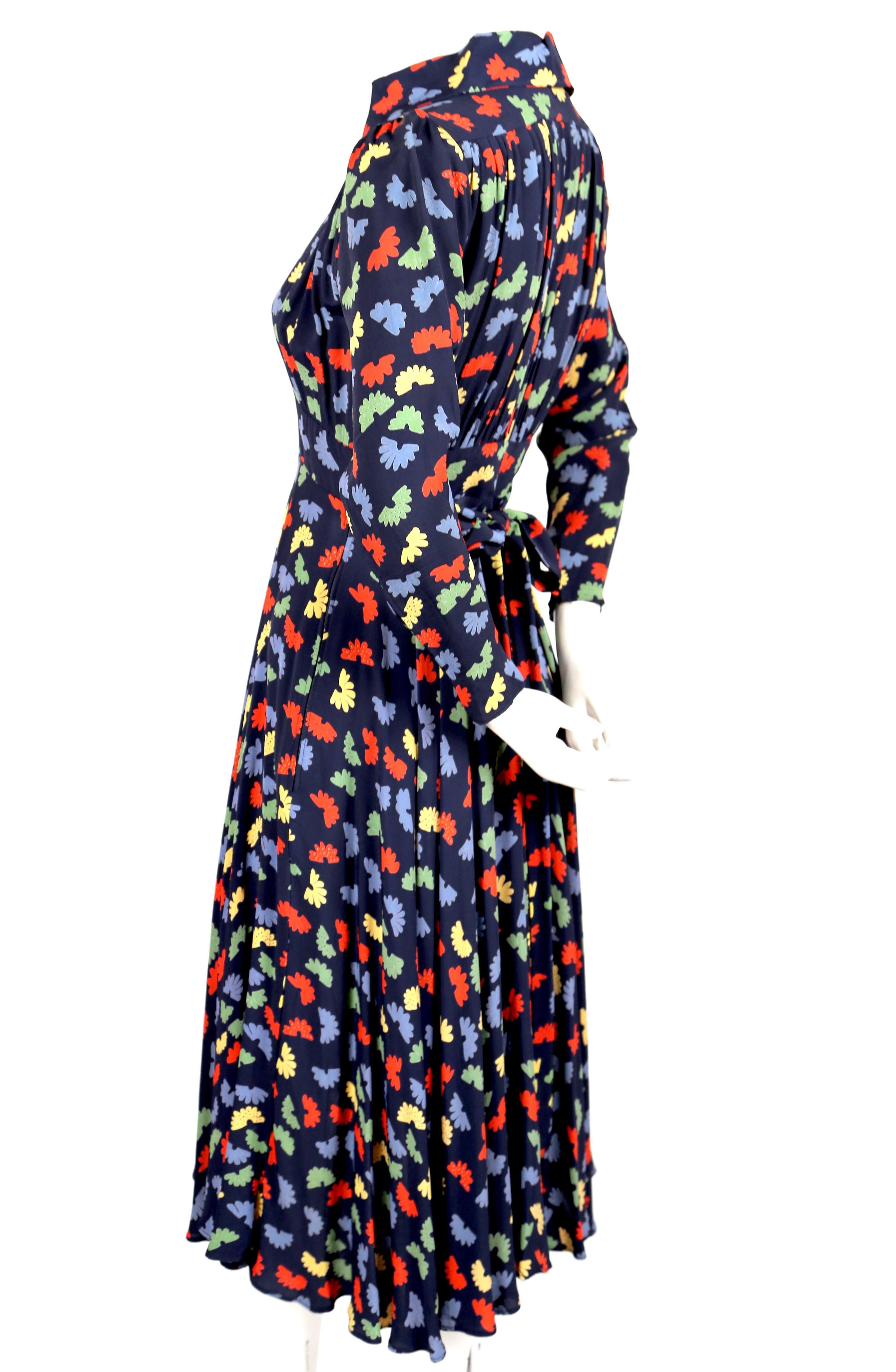 Very rare, Ossie Clark dress from Quorum dating to the 1970's. Celia Birtwell fan printed fabric. Plunging neckline. Zips up side. Adjustable ties at back. Colors are blue, red, yellow, and green. Covered buttons at wrists. Labeled a UK size 8 which