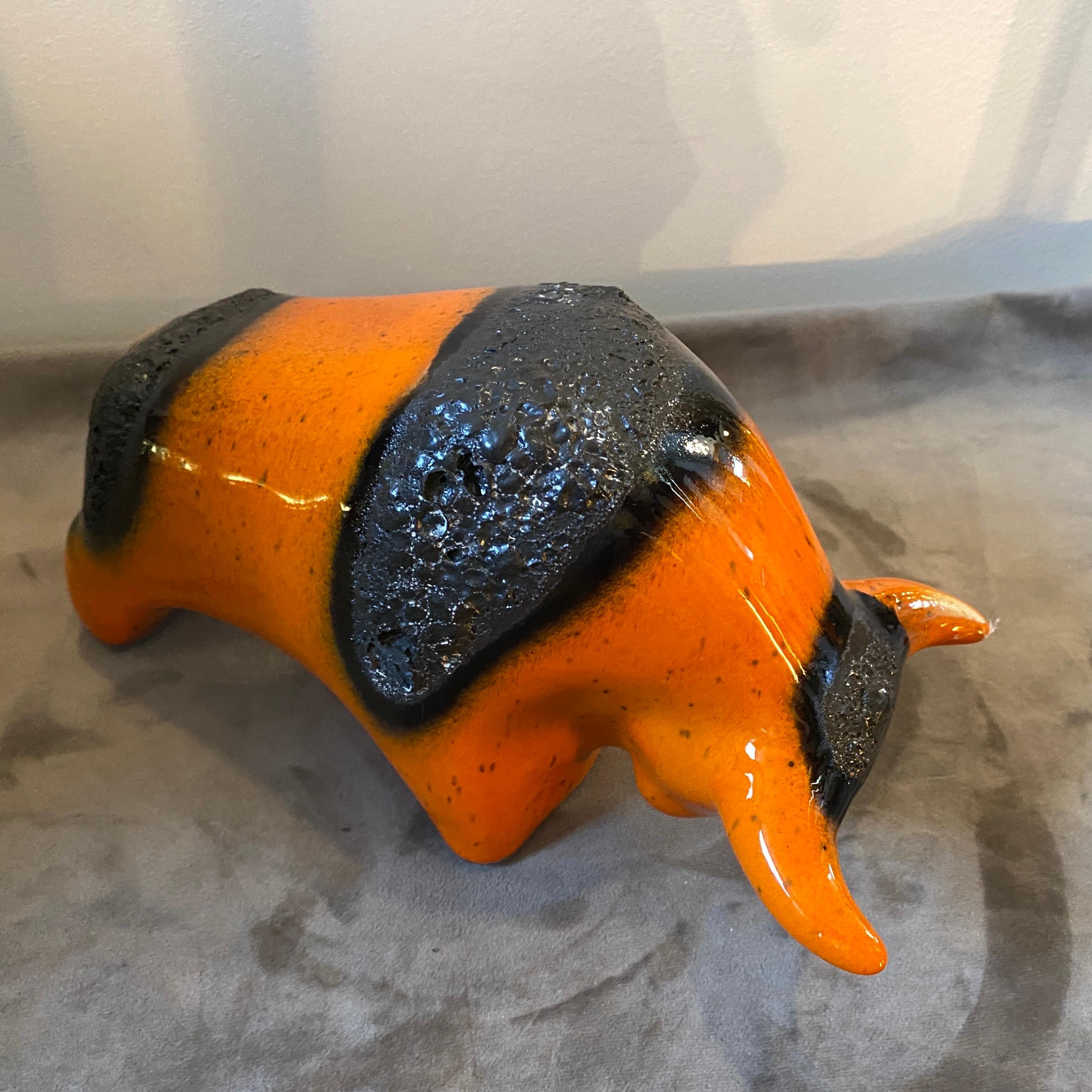 A stylish orange and black ceramic bull made in Germany in the Seventies by Otto Keramik. Fat lava pottery takes its name from its resemblance to volcanic lava and was very popular in the Seventies all over the Europe. The bull it's in perfect
