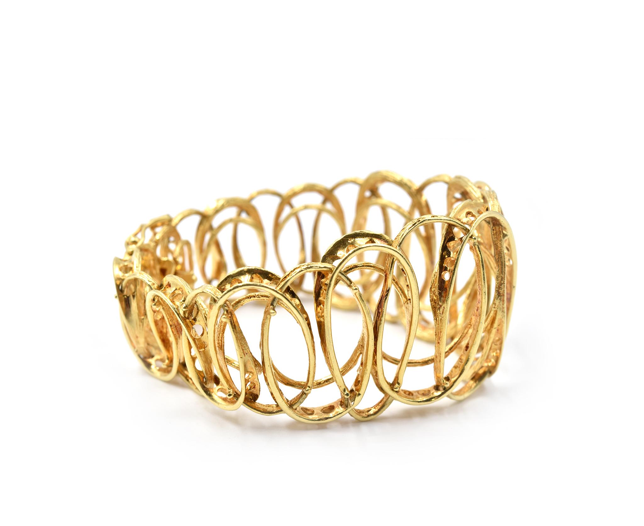 Designer: custom design
Circa: 1970s
Material: 18k yellow gold
Dimensions: bracelet is 7 1/2-inch long and 1 1/4-inch wide
Weight: 54.84 grams

