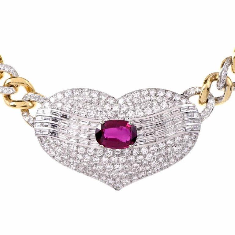 This conspicuous link chain pendant choker necklace of sophisticated aesthetic is crafted in a combination of 18K yellow and white gold. It exposes at the center a romantically designed heart motif décor, centered with a prominent 4.11carat