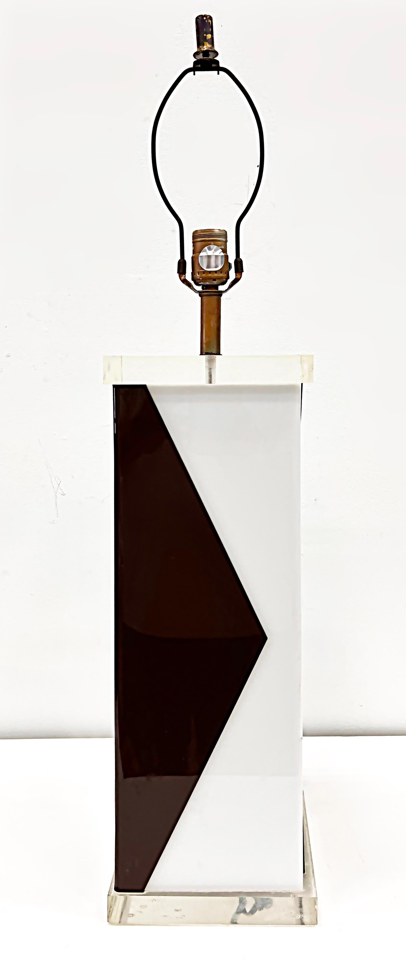 1970s Overscale Geometric Lucite and Acrylic Lamp

Offered for sale is an overscale 1970s Lucite and two-tone acrylic lamp that has been created in a geometric design.  The lamp's body is chocolate brown and white acrylic with a Lucite cap and a