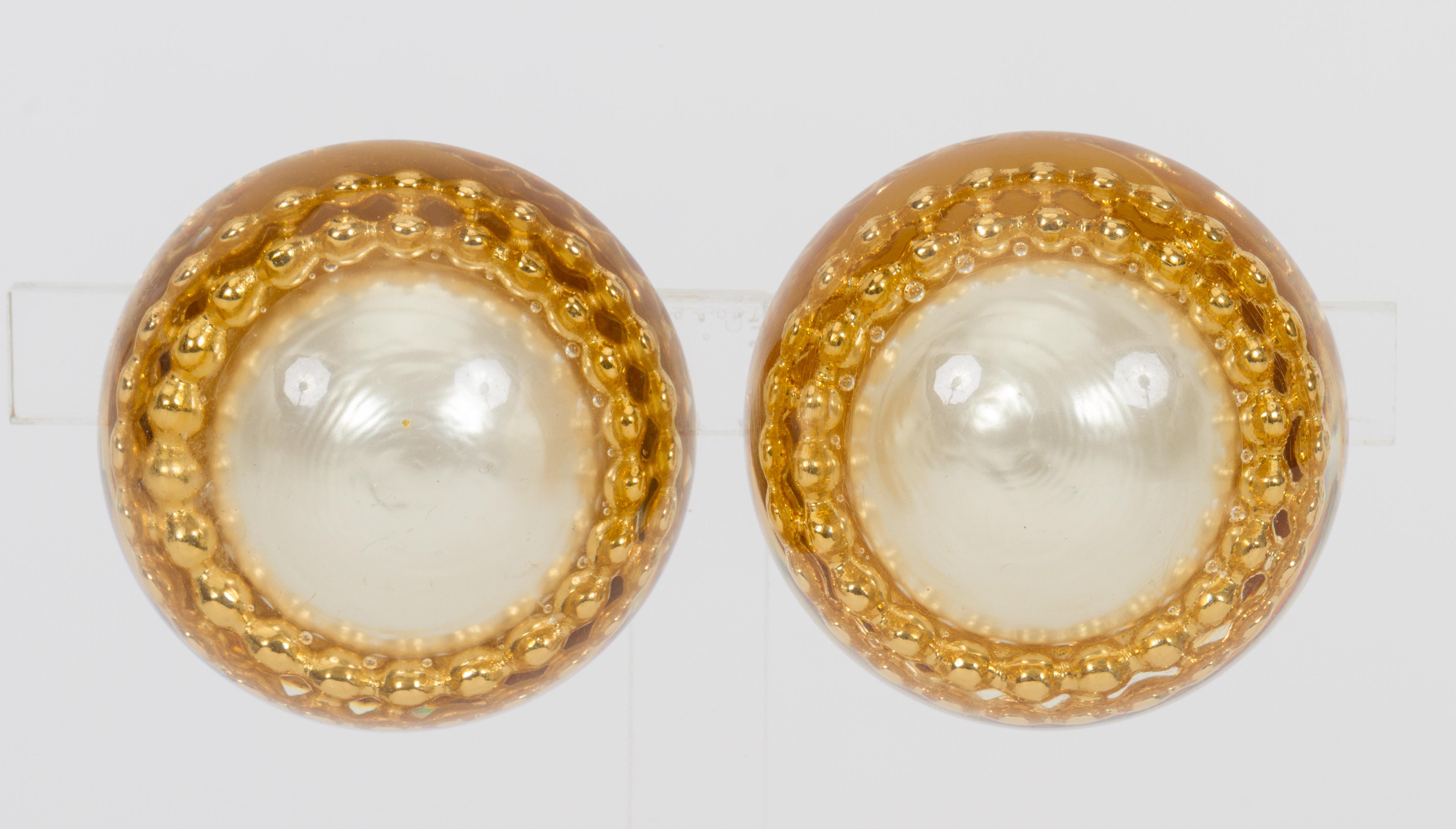 1970s Chanel oversize Lucite and faux-pearl inlay earrings. Clip backs. Comes with original pouch or box.