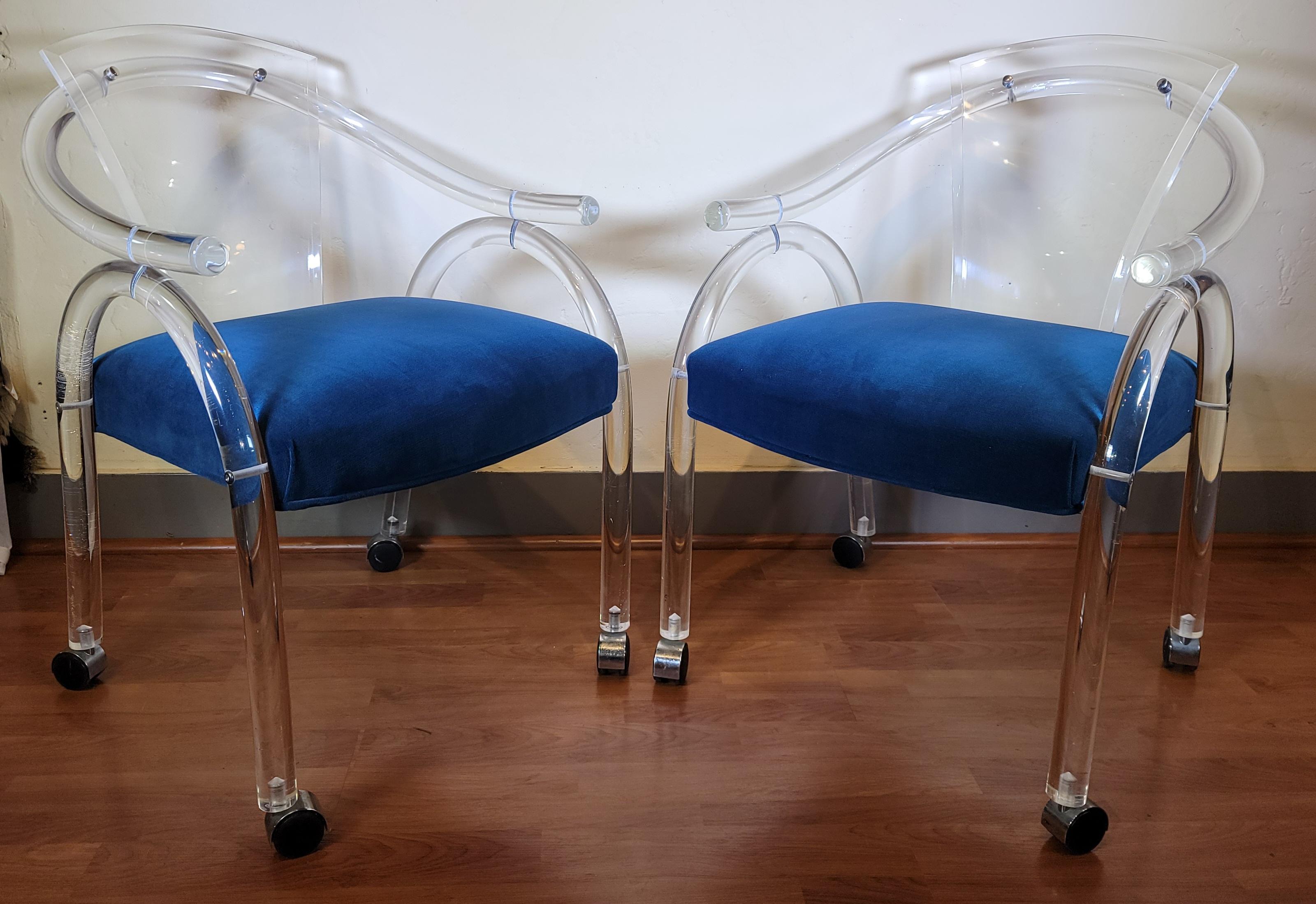 Pair of 1970s Acrylic Charles Hollis Jones style chairs. Great curved shape to the body. Very strong and sturdy chairs with rollers for ease of use. Acrylic has a wonderful shine when hit by light.