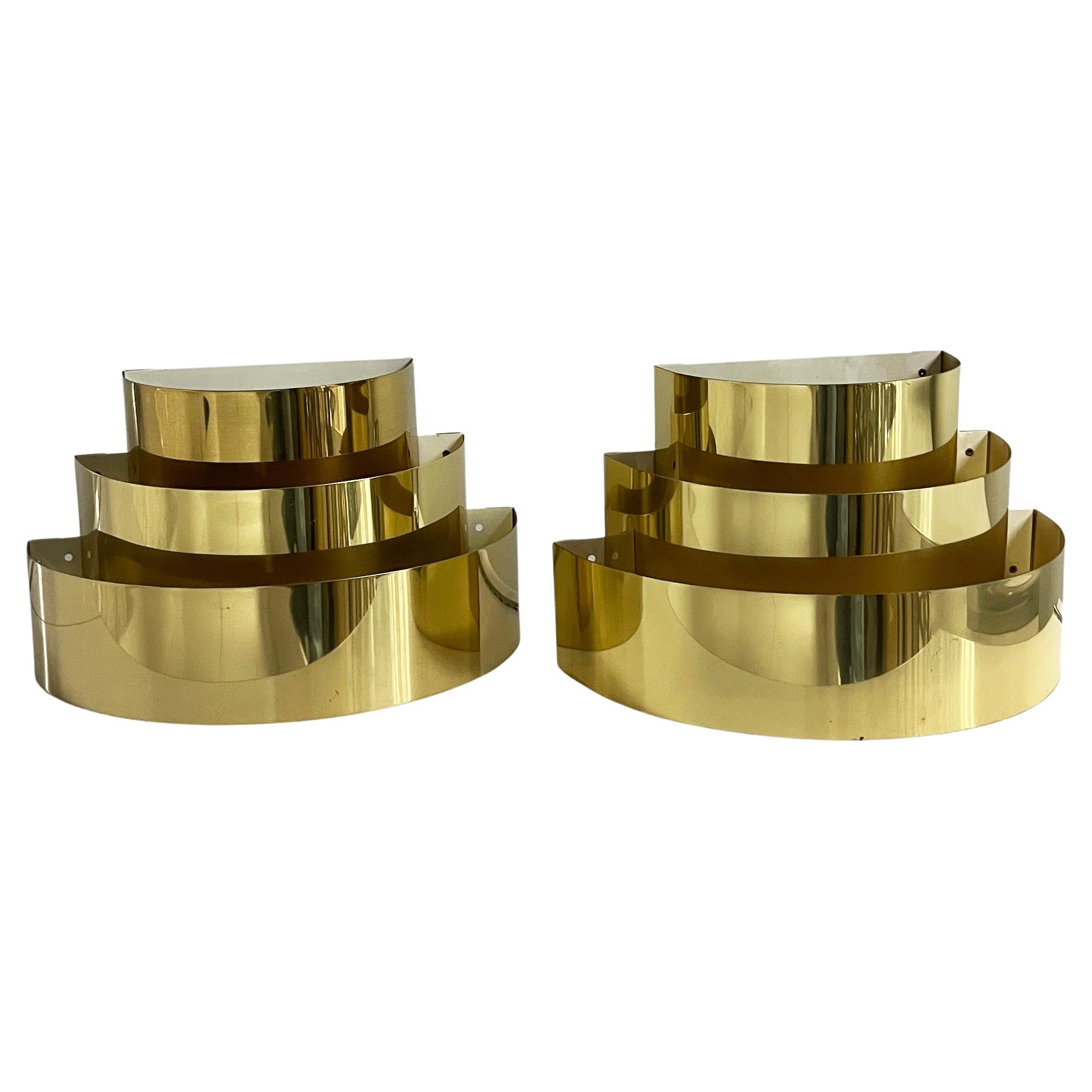 1970s Vintage brass with a shine finish, 3 tier wall sconces. No maker's mark but I believe Lightolier made these in the late 1970s or early 80s. They are in good condition with a few small imperfections and age spots to the finish. Tested and work