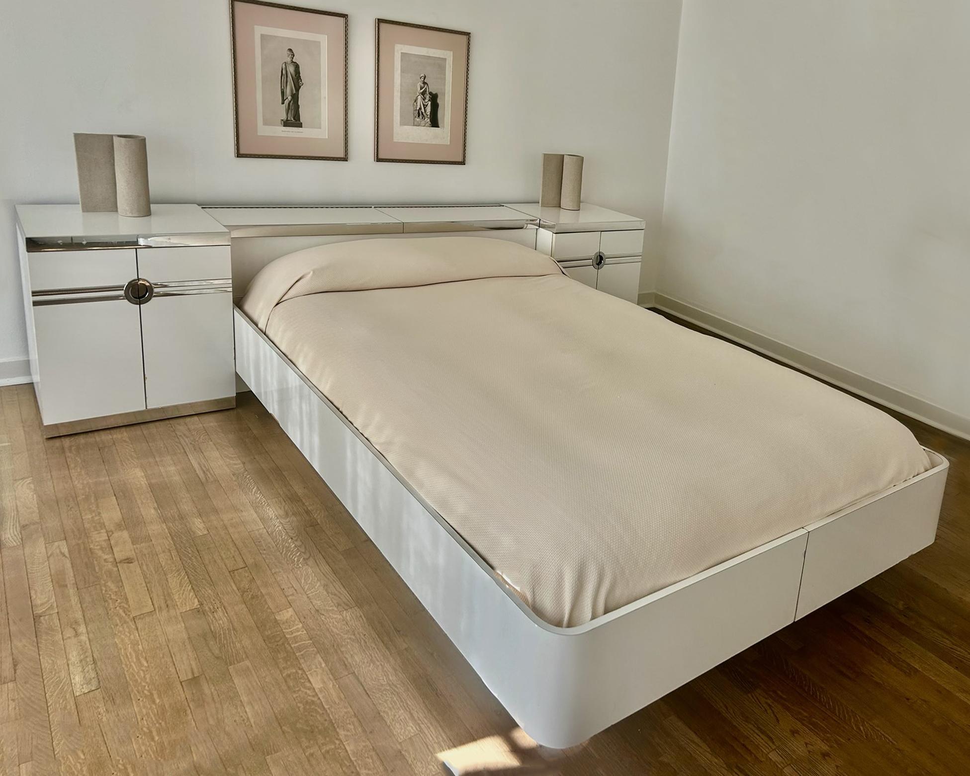 Beautiful pair of nightstands designed by Pierre Cardin in the 1970s and produced in France. White lacquer with polished aluminum to chrome finish trim is in an Art Deco style. Each has an interior pullout / pull-out drawer and shelf. Manufactures