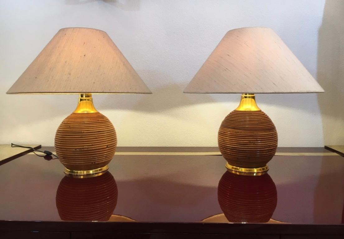 Decorative pair of bamboo and brass table lamps ca. 1970s 
Paper shade, very good condition
Measure: H 57 x D 55 cm
2 pair available.