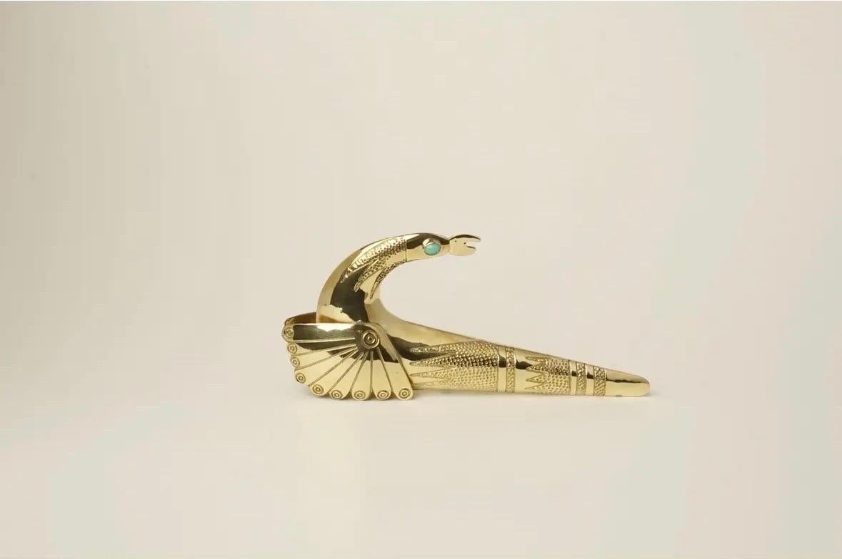 Spanish name: Ave Dragón, Translation: Dragon Bird

Pair of handmade polished brass dragon birds with abstract embossed and engraved details. Each sculpture is uniquely engraved with designs to compliment its elegant modern form.

Encrusted gemstone
