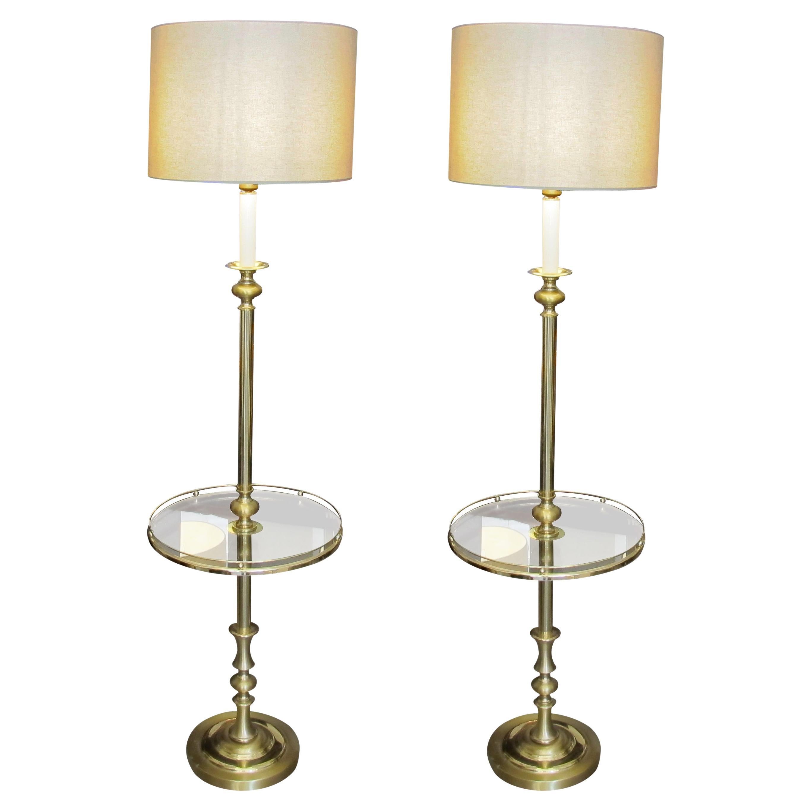 At the heart of these lamps lies a unique feature; a round clear glass encased within a meticulously crafted brass frame. With its pristine transparency, the clear glass enhances the lamp's aesthetic allure but also serves as a functional surface.
