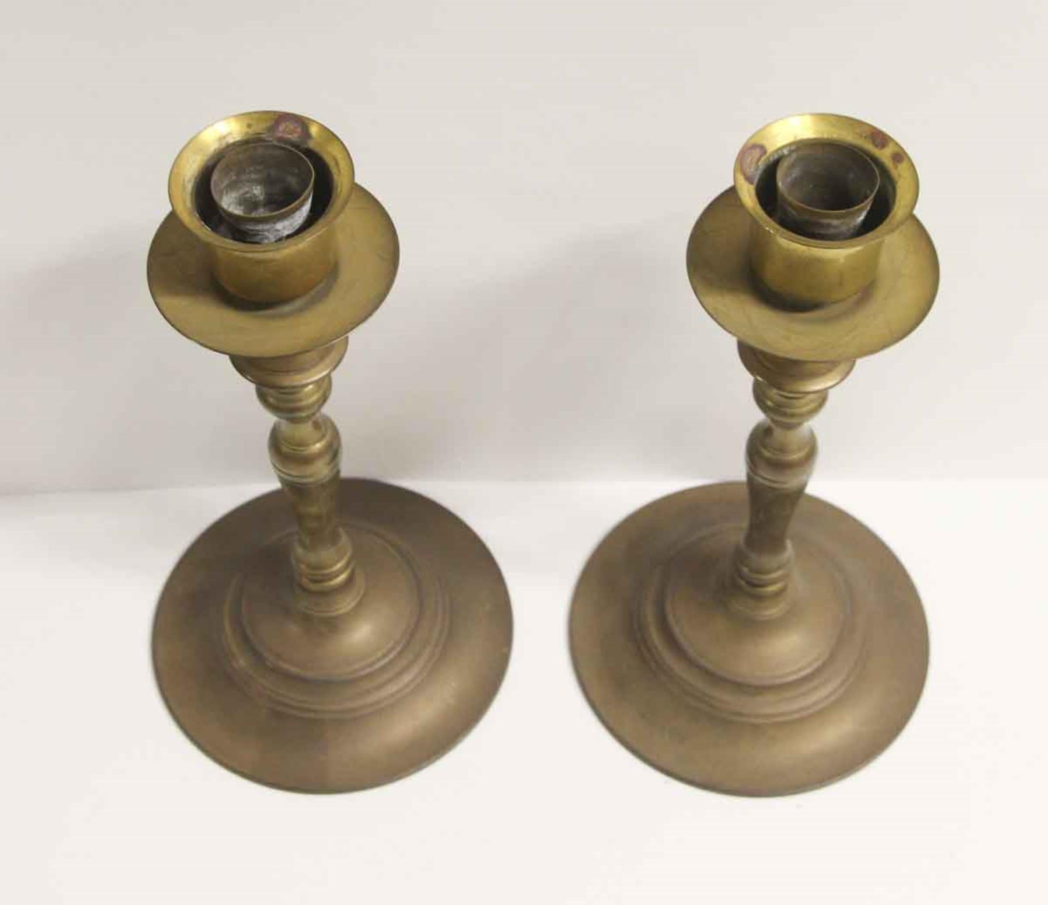 1970s pair of brass tabletop candlesticks with the original antique patina. This can be seen at our 302 Bowery location in NoHo in Manhattan.