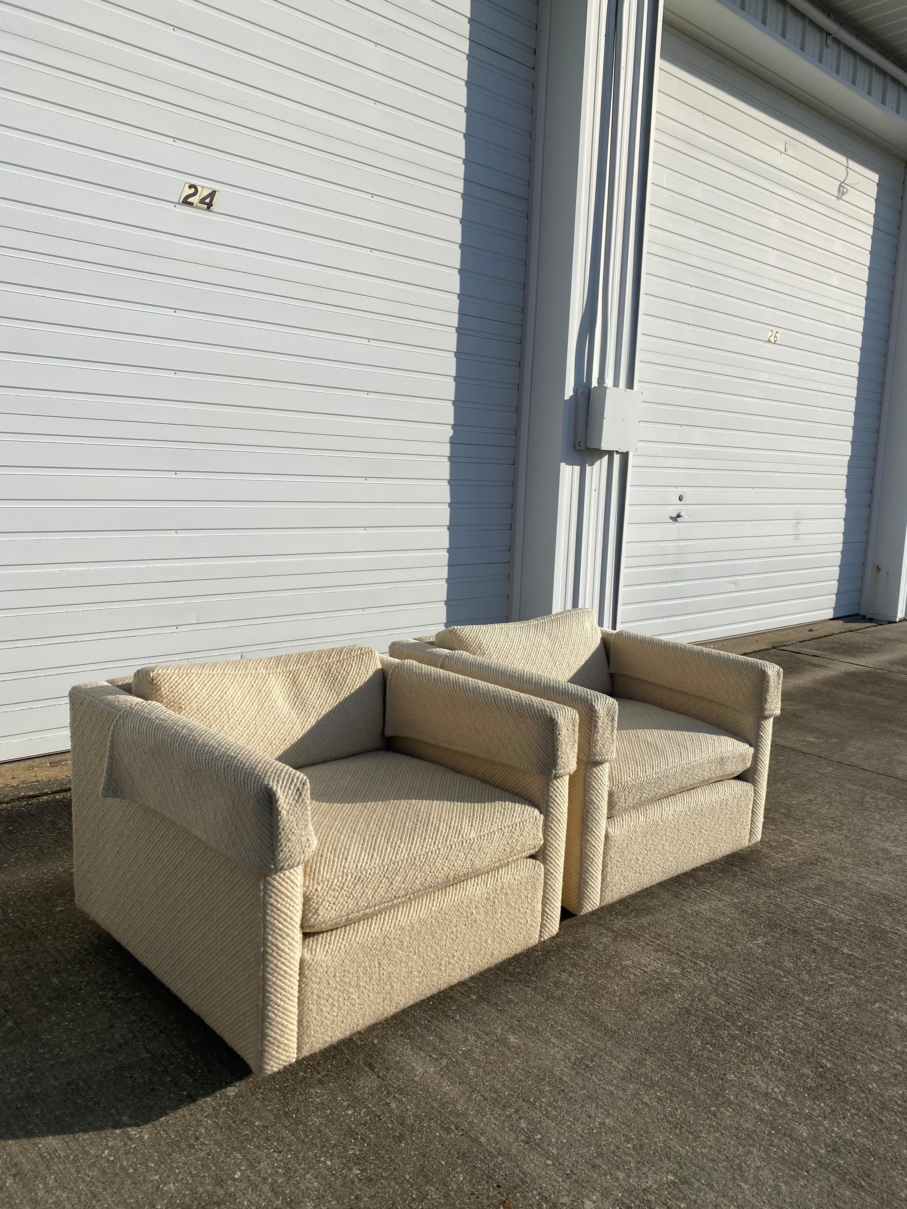 Gorgeous pair of Charles Pfister cube lounge chairs for Knoll in its original elegant wool fabric. These chairs sit on a four shepherd castors on each but come with original replacement chrome Knoll legs, with the ability to make chairs stationary.