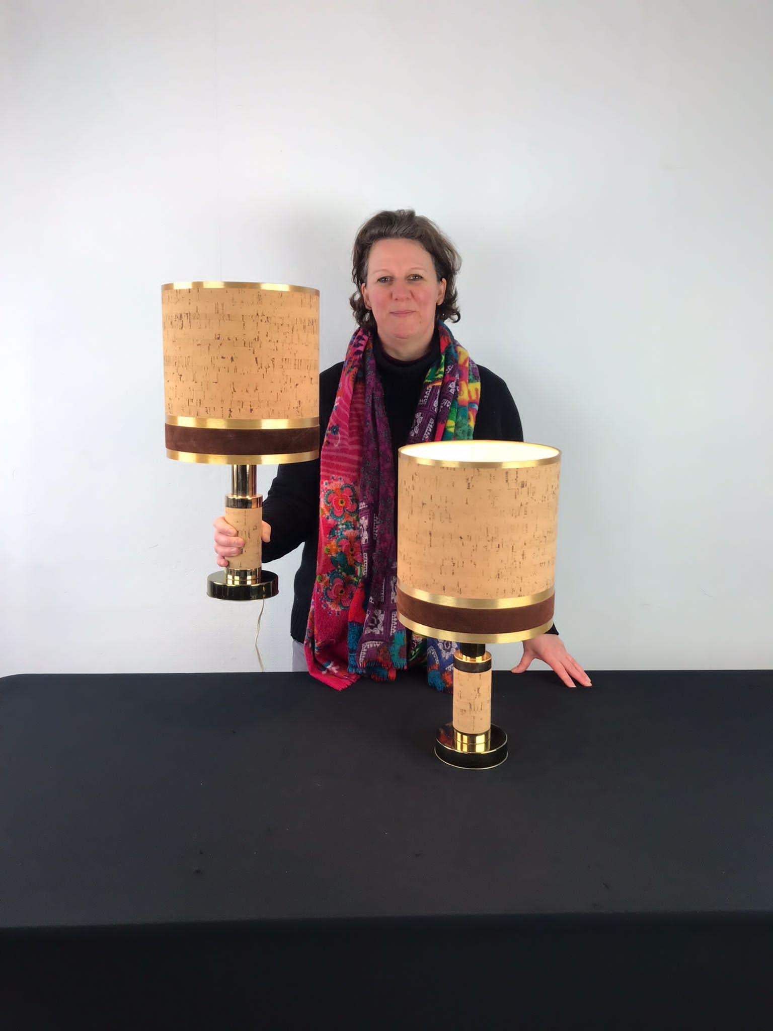 Pair of cork table lamps. 
1970s table lamps which will look great in your interior. 
As well the base as the lampshade have a beautiful thin layer of cork. 
The round base is made of brass plated metal and the lampshade has besides the cork also