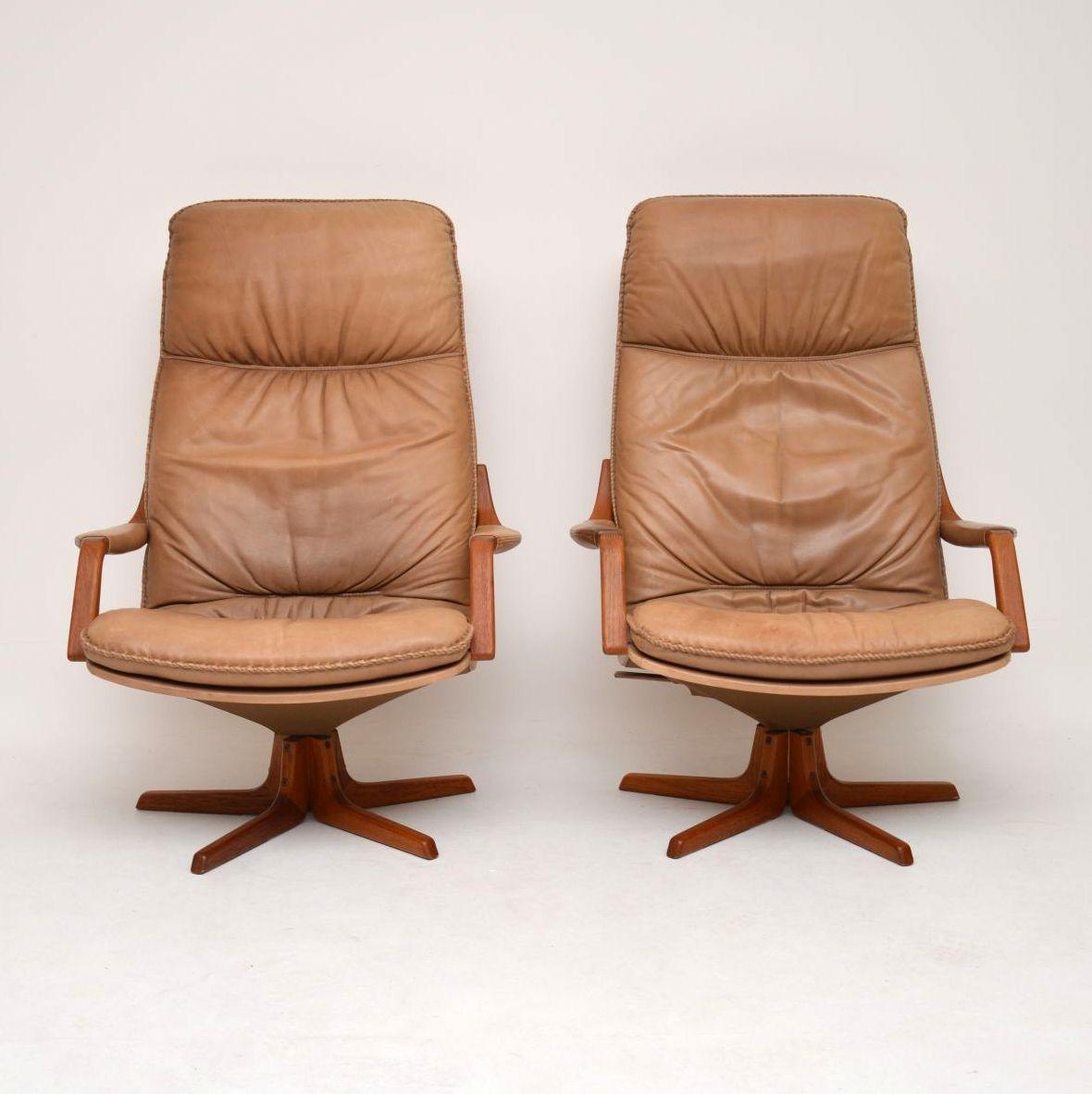 A stunning and extremely comfortable pair of Danish leather armchairs by Berg, these date from around the 1970s. They are of amazing quality, they both swivel, rock and recline, they can be locked into a tilted angle. The light tanned leather has a