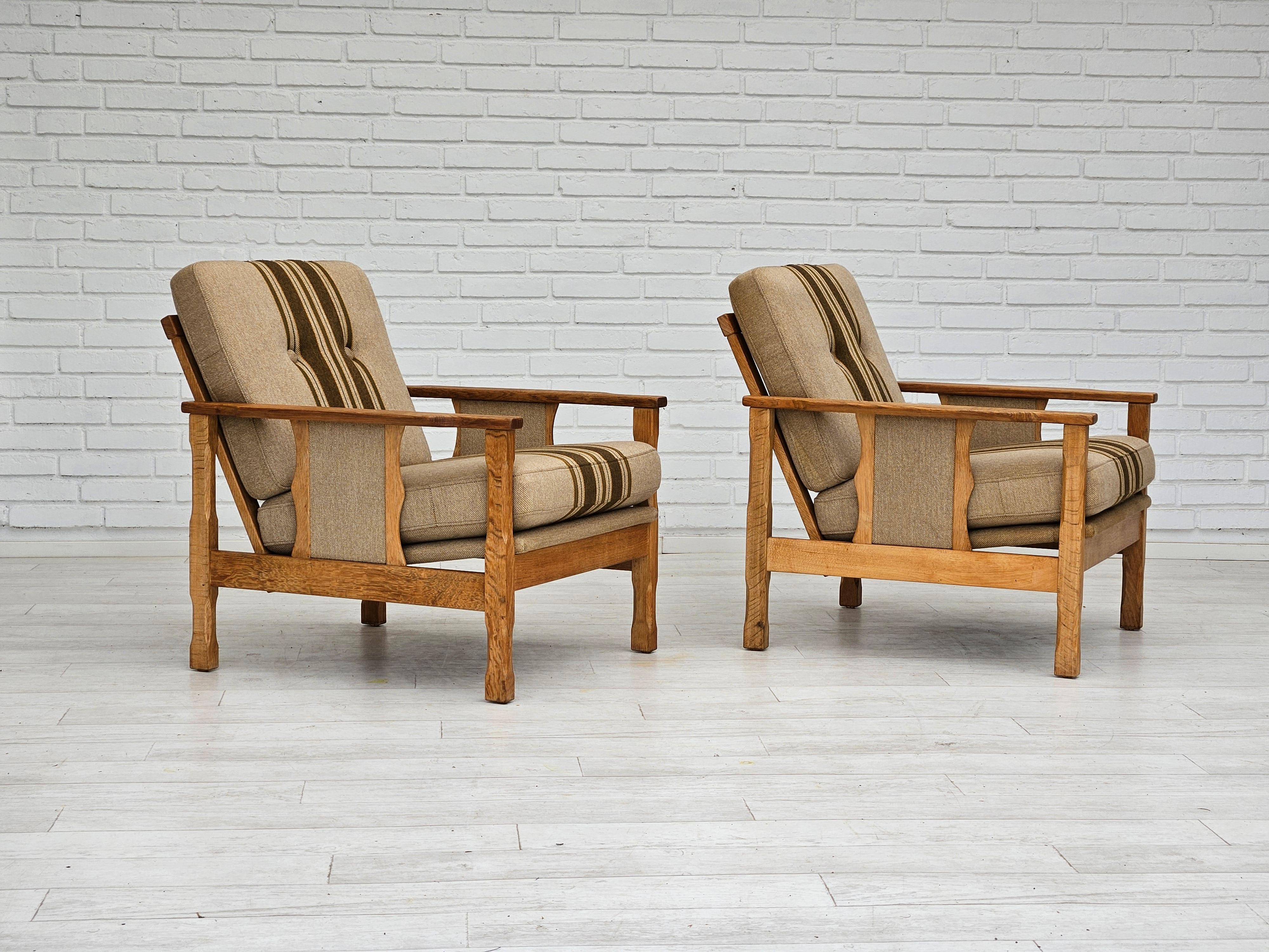 1970s, pair of Danish lounge chairs in original very good condition: no smells and no stains. Furniture wool fabric, oak wood. Removable cushions. Manufactured by Danish furniture manufacturer in about 1970s. ( price for set of two chairs )