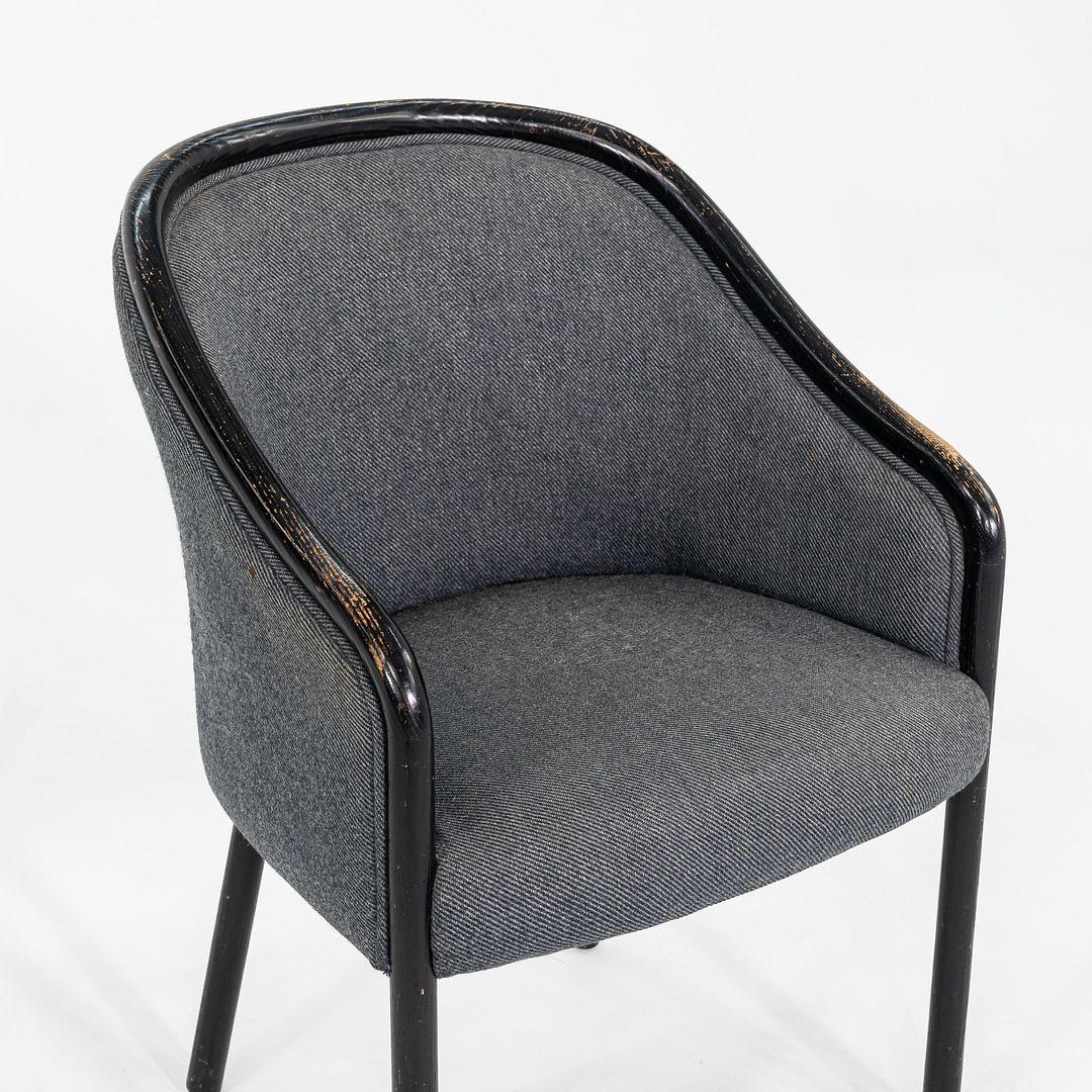 This is a pair of dining chairs in the style of Ward Bennet for Brickel Associates. It is unknown where these pieces were produced but they date to the 1970s. They are comprised of a wooden frame with seats upholstered in grey fabric. 

The listed