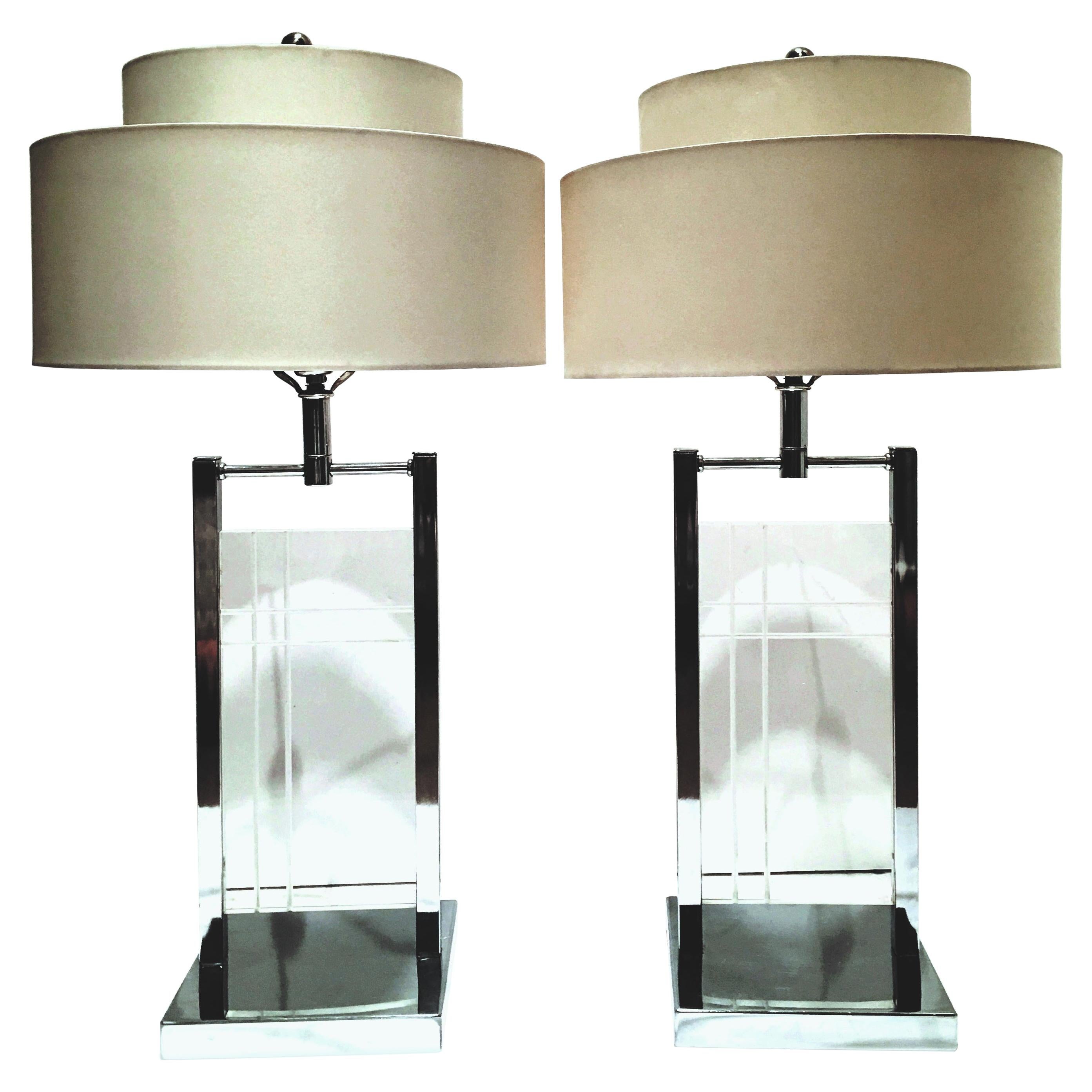 1970s pair of etched Lucite panel and chrome table lamps by George Kovacs. Features a geometric clean line etched motif on Lucite slab panel with chrome fittings. The Lucite panel measures, 13