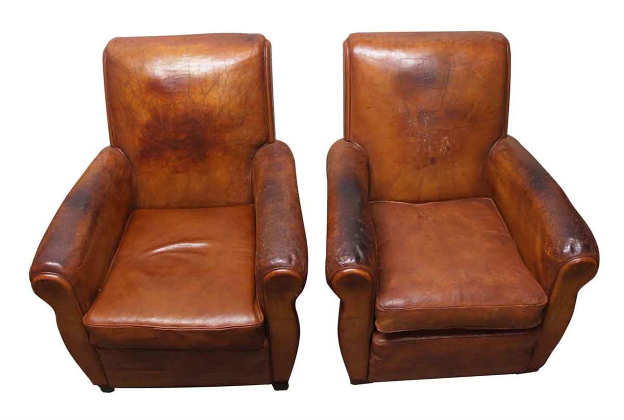 1970s pair of brown leather club chairs from France. They have general wear and tear from age and use. Priced as a pair. This can be seen at our 302 Bowery location in Manhattan.