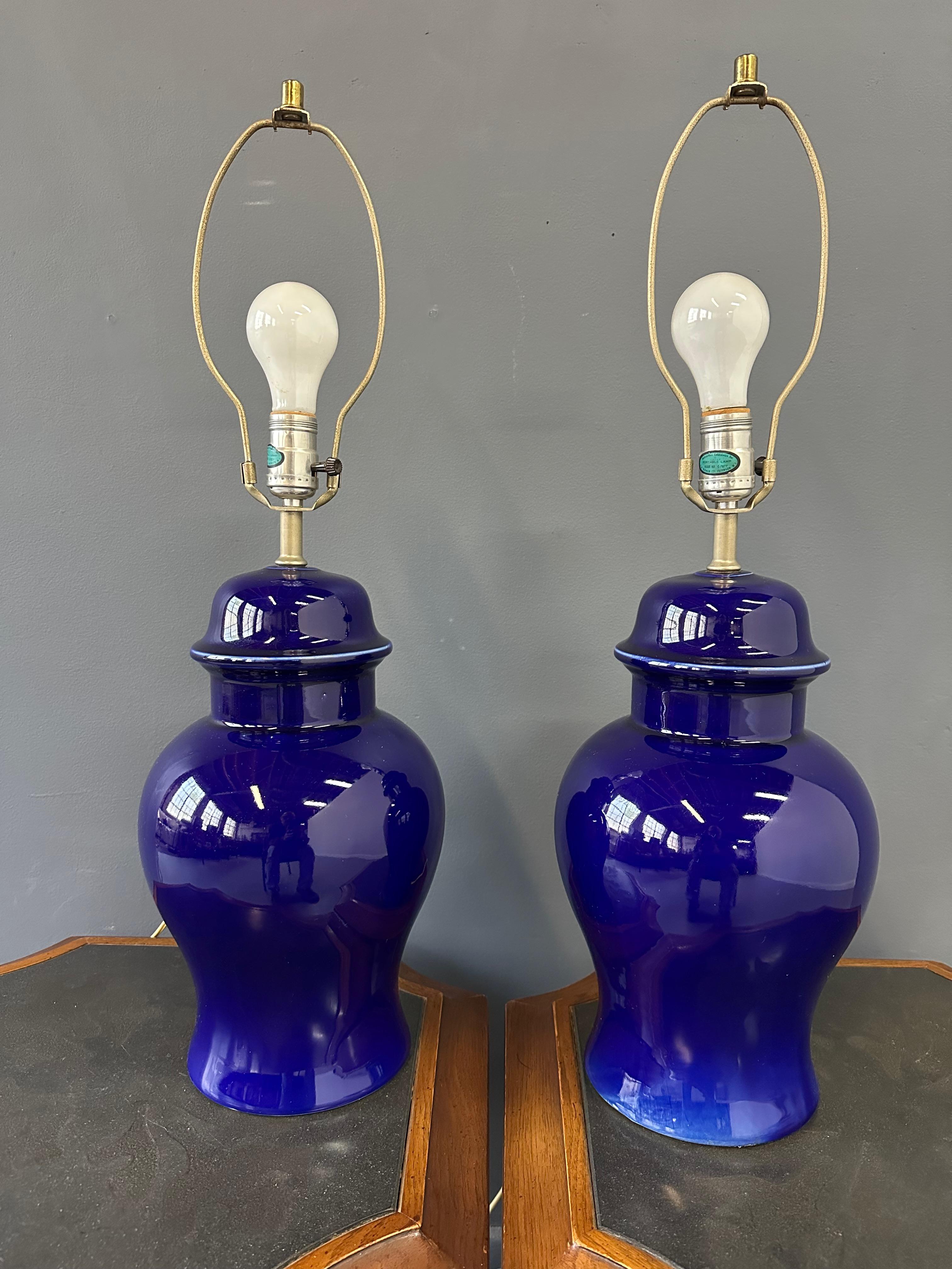 Cette paire de lampes en céramique des années 1970 rehausse la décoration de votre maison. Avec leur forme intemporelle de pot de gingembre et leur couleur bleu cobalt audacieuse, ces lampes ne manqueront pas d'ajouter une touche d'élégance et de