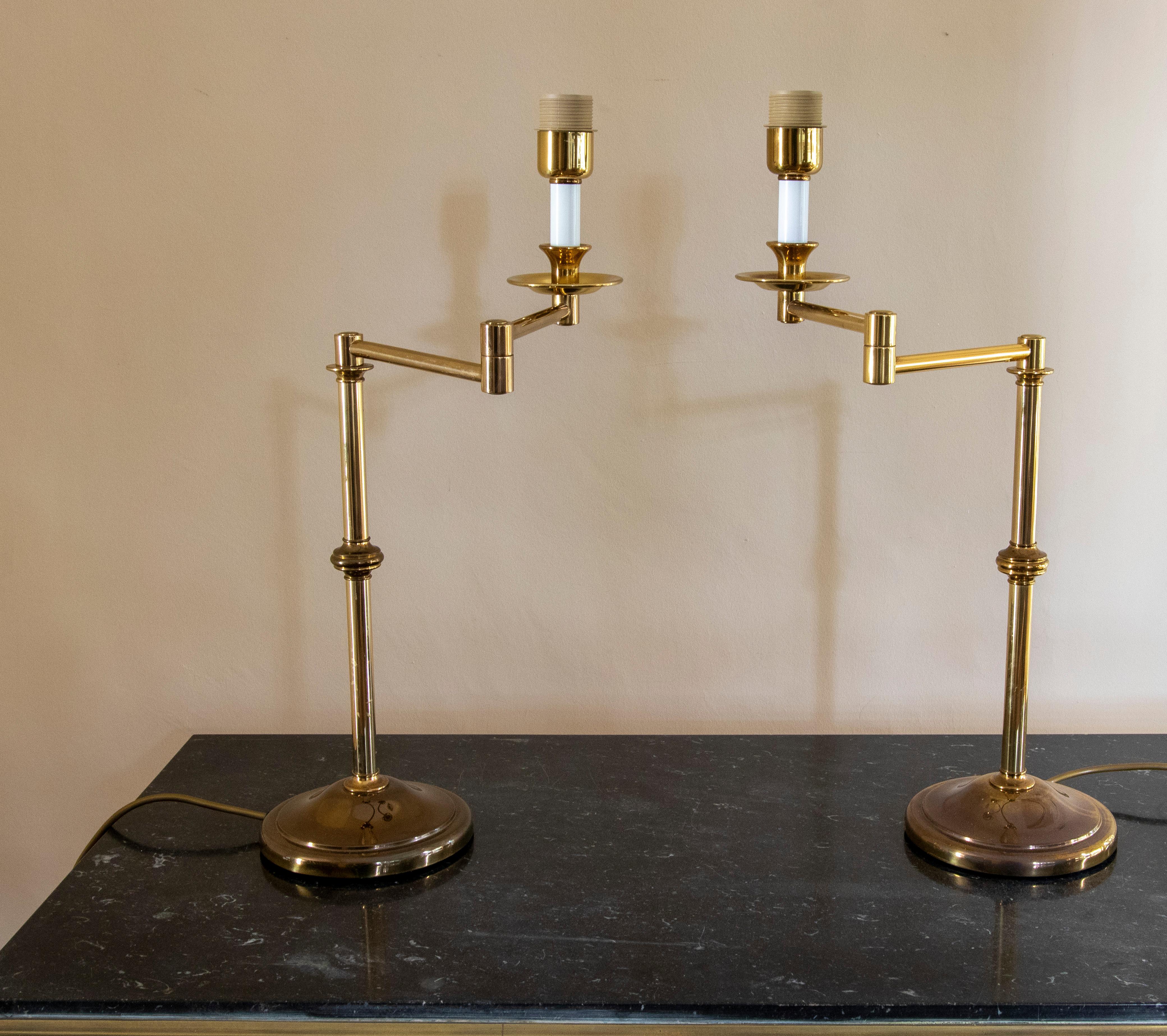 1970s Pair of golden brass articulated table lamps.