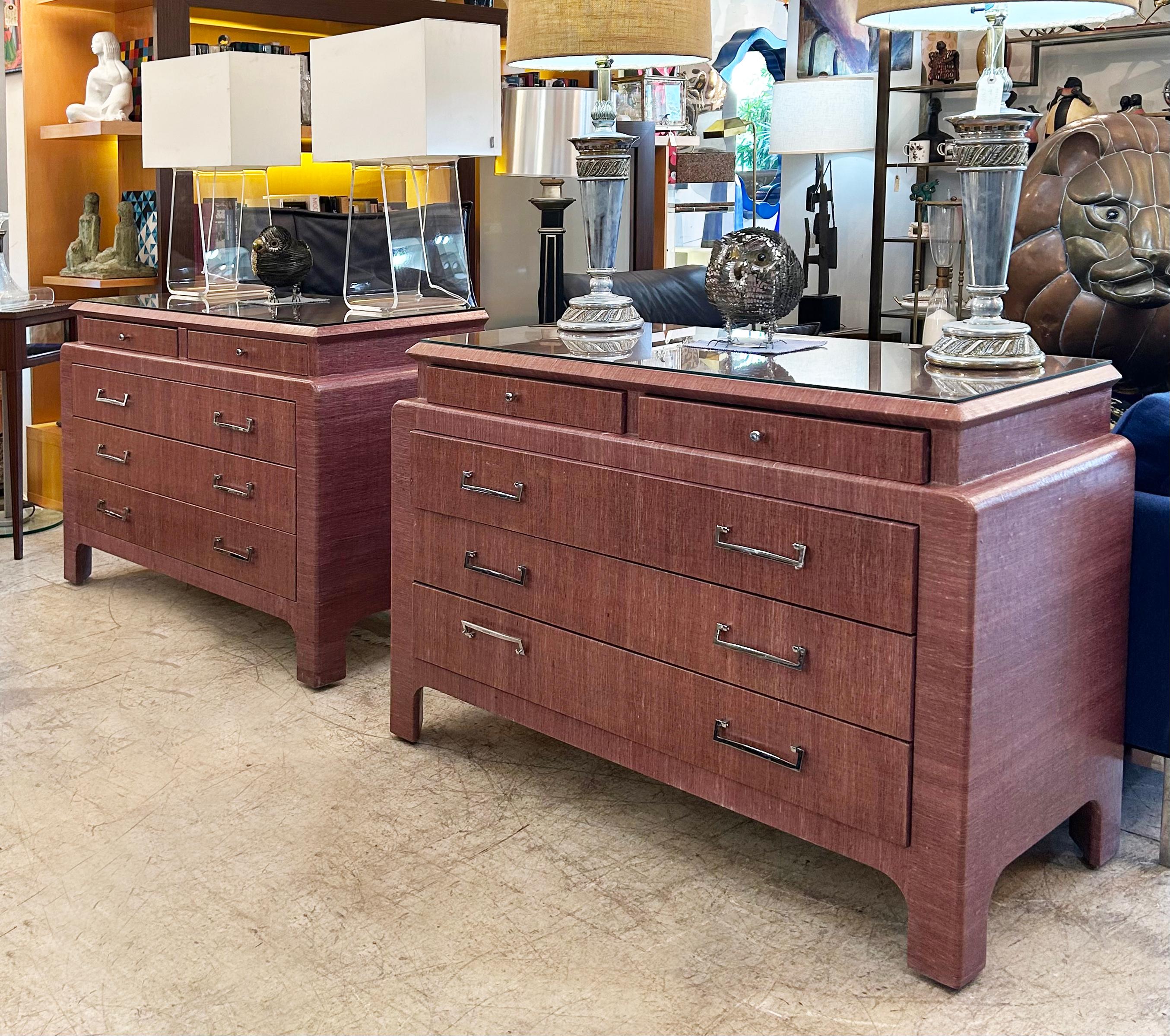 1970s Pair of Grasscloth Clad Chests of Drawers, Karl Springer Attributed 

Offered for sale is a pair of wonderful chests of drawers covered in plum-colored grasscloth. The chests have glass tops to protect the tops and are a recent acquisition