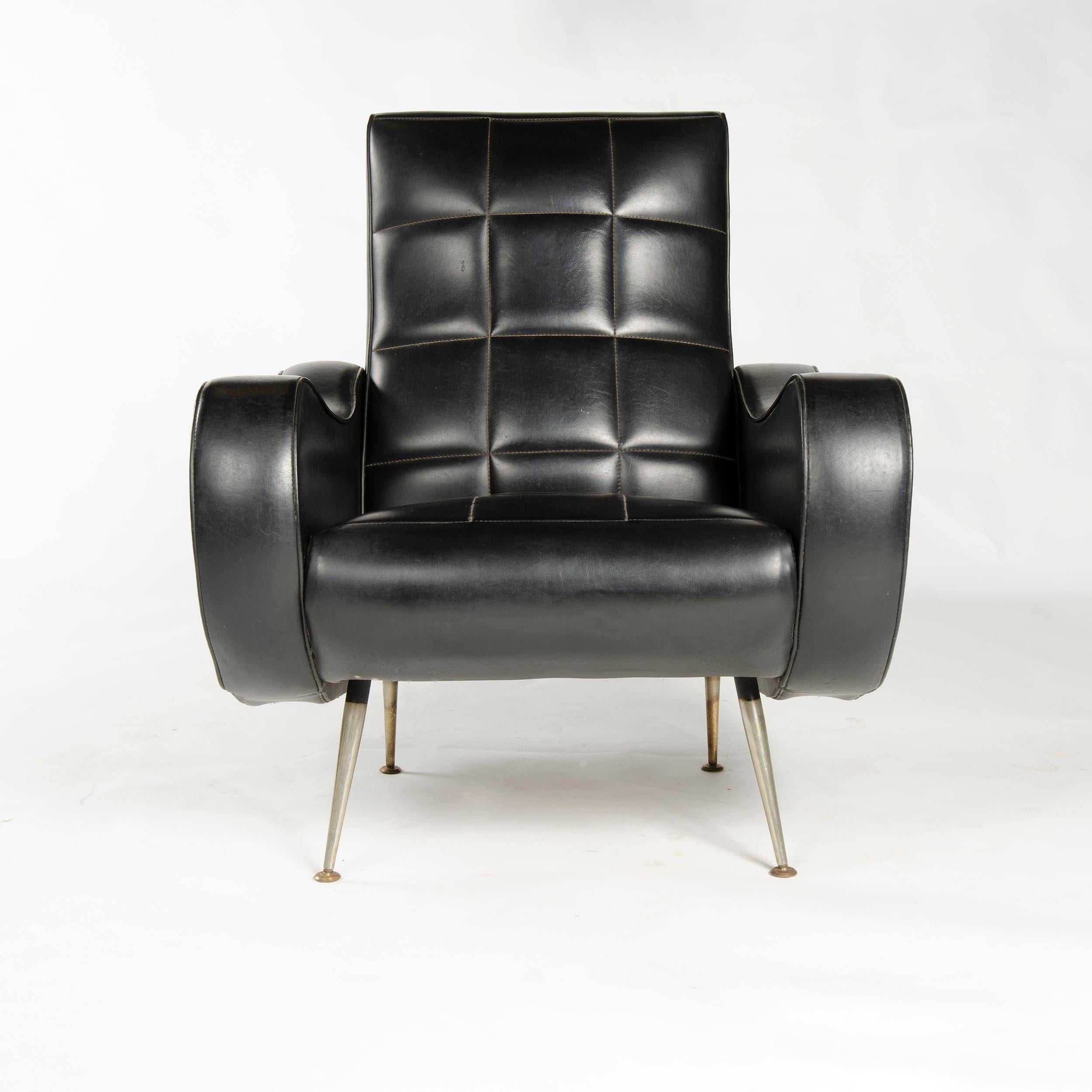 A pair of lounge chairs in original black vinyl upholstery, with thick slab arms and grid stitched backs on chromed legs.