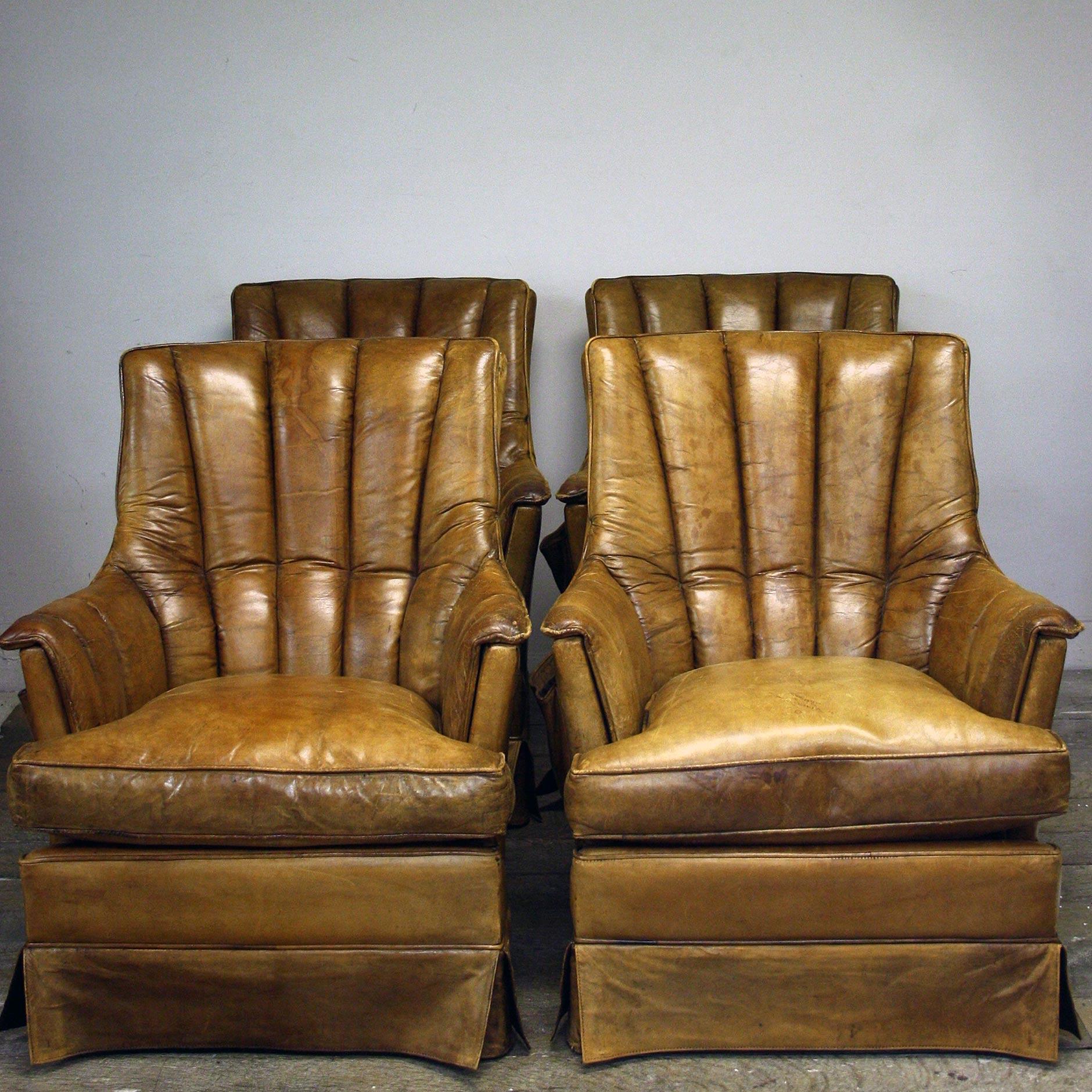 A 1970s pair of Leather armchairs with a scalloped shape back and an extremely handy magazine much on the side. 

Perfect amount of age with no splits on the leather.