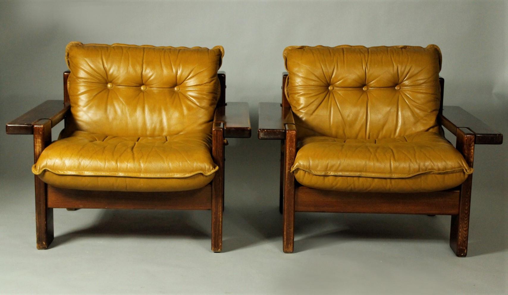 Pair of leather club chairs from the 1970s, manufactured by Vilka Elamisen Iloksi, Finland. They are in good original vintage condition with patina. Base is made from nordic pine and vinyl, leather cushions.